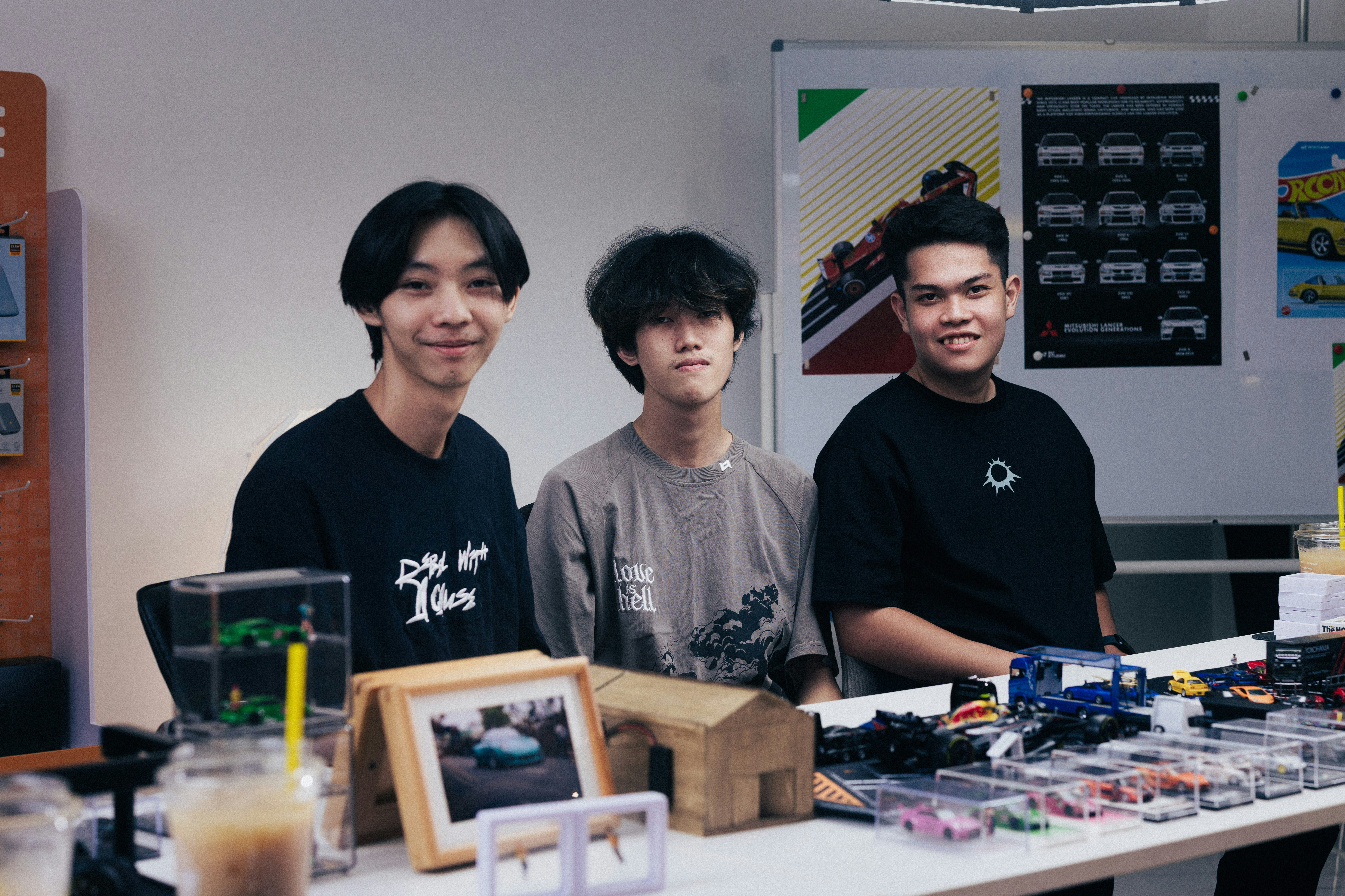 Three young people behind a table with products