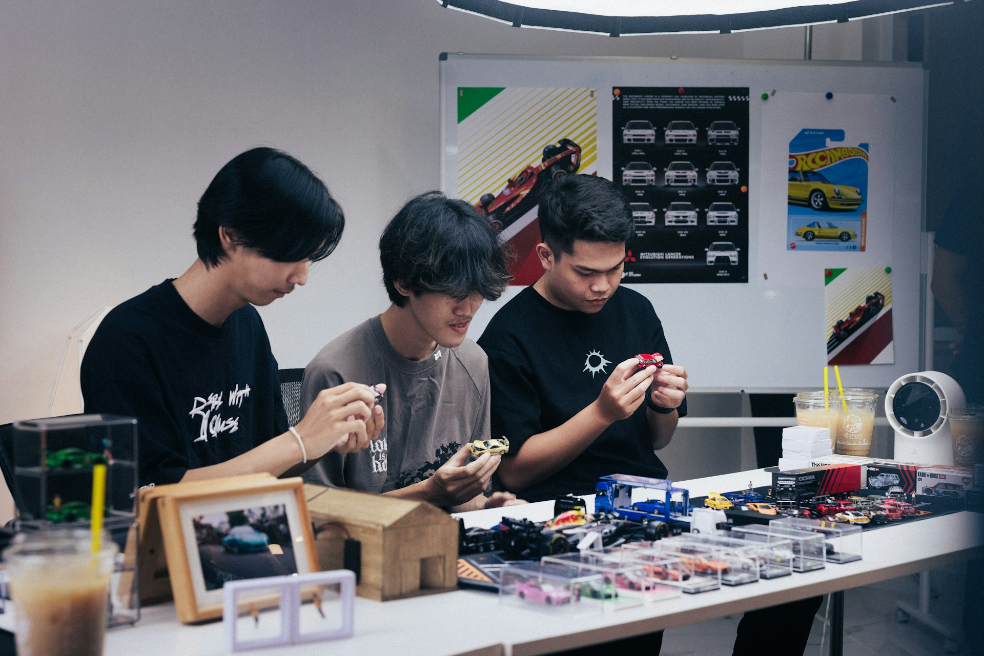 Three people focused on a table with items