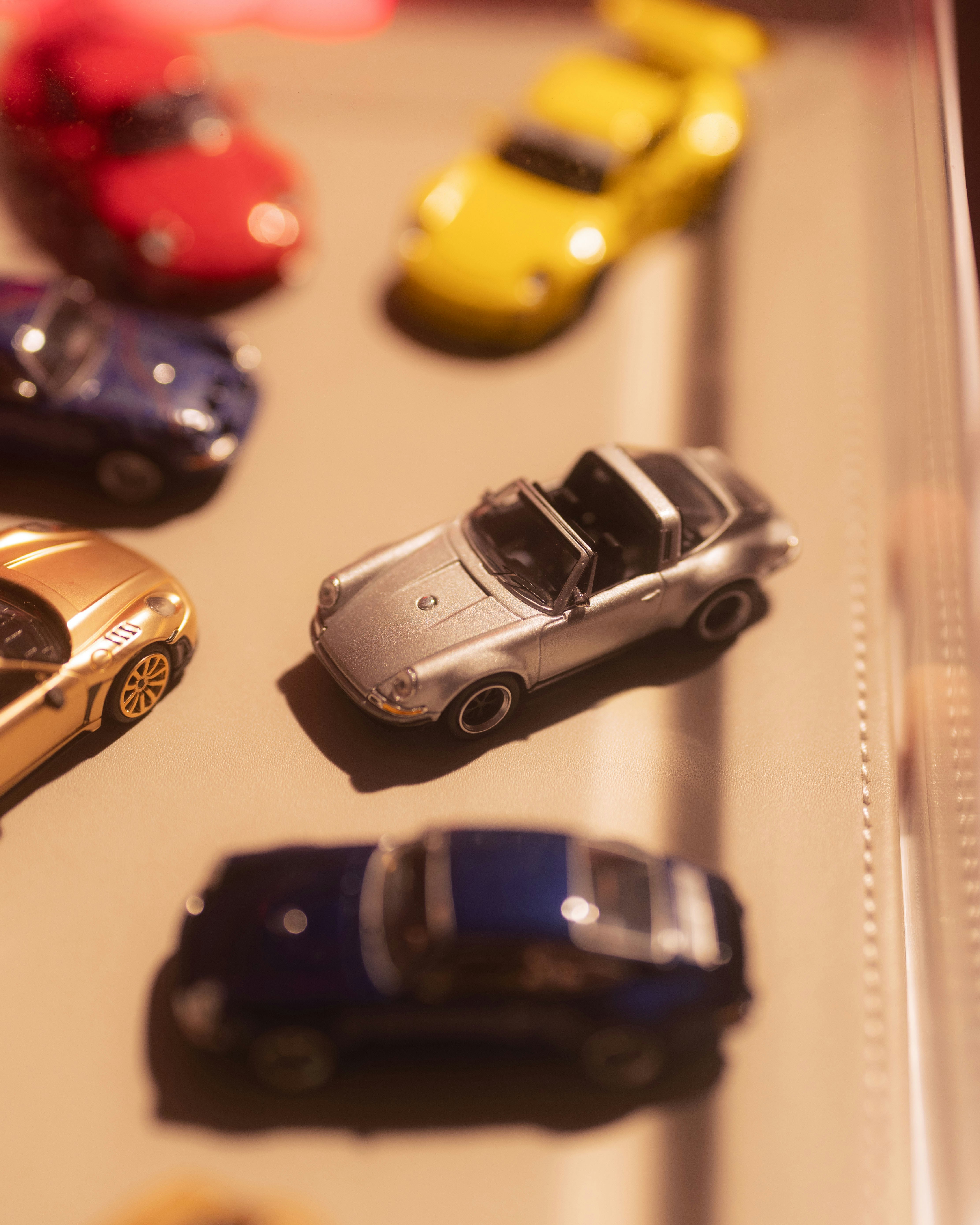 Several colorful miniature cars arranged on a surface.