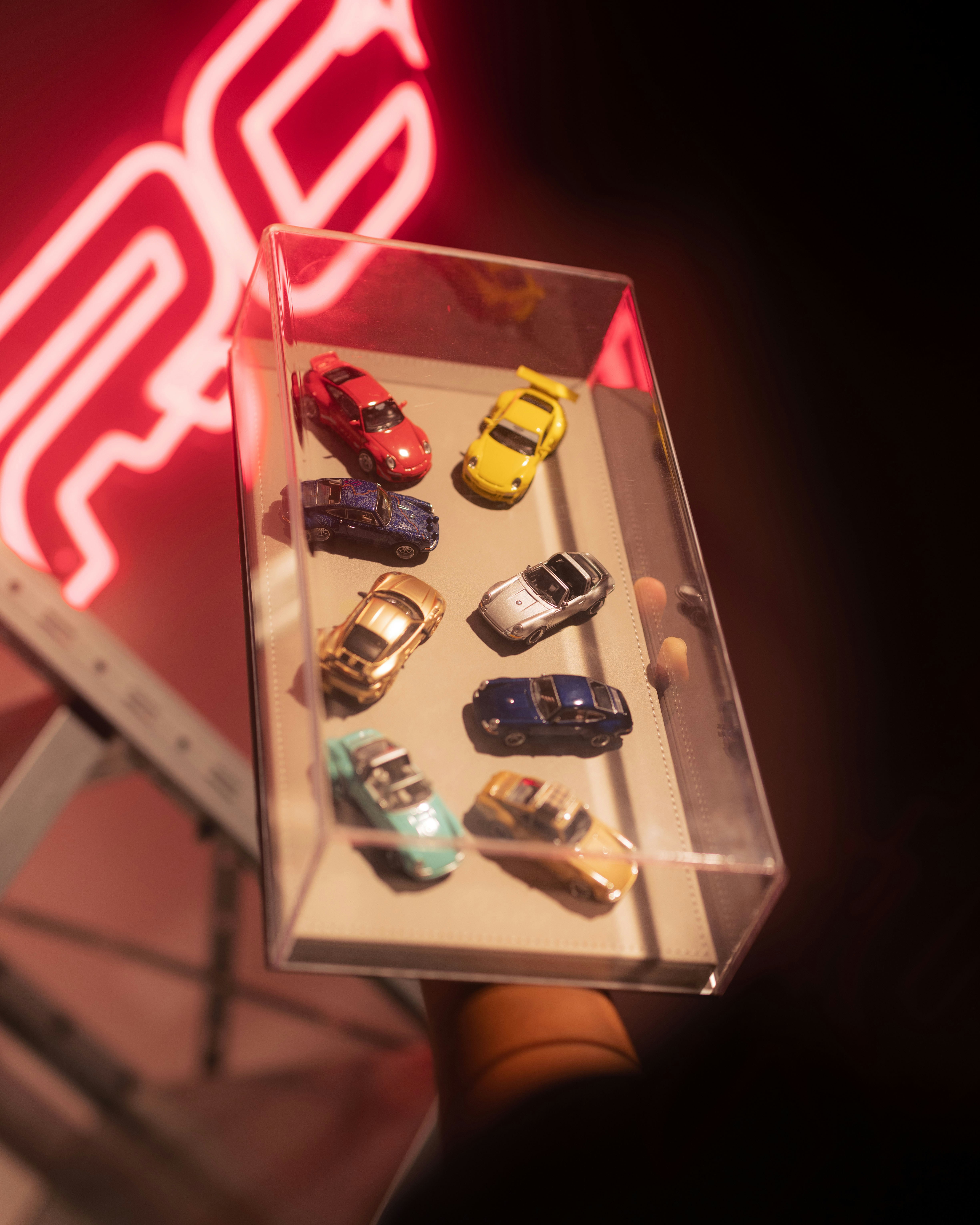 Collection of small toy cars in a display case.