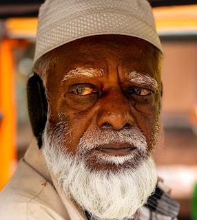 Elderly man with white beard and cap