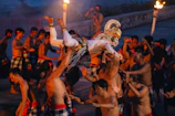 Dancers perform a traditional ritual with torches at night.