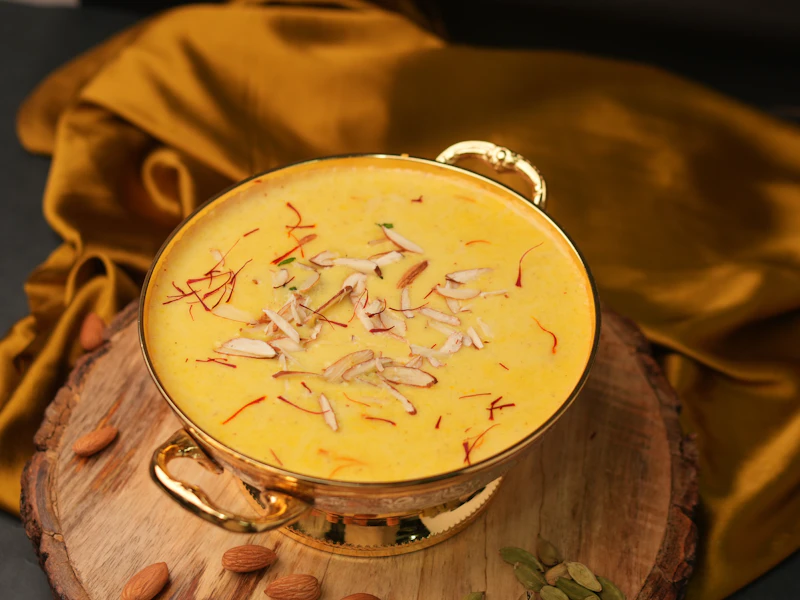 A bowl of saffron shrikhand garnished with pistachio