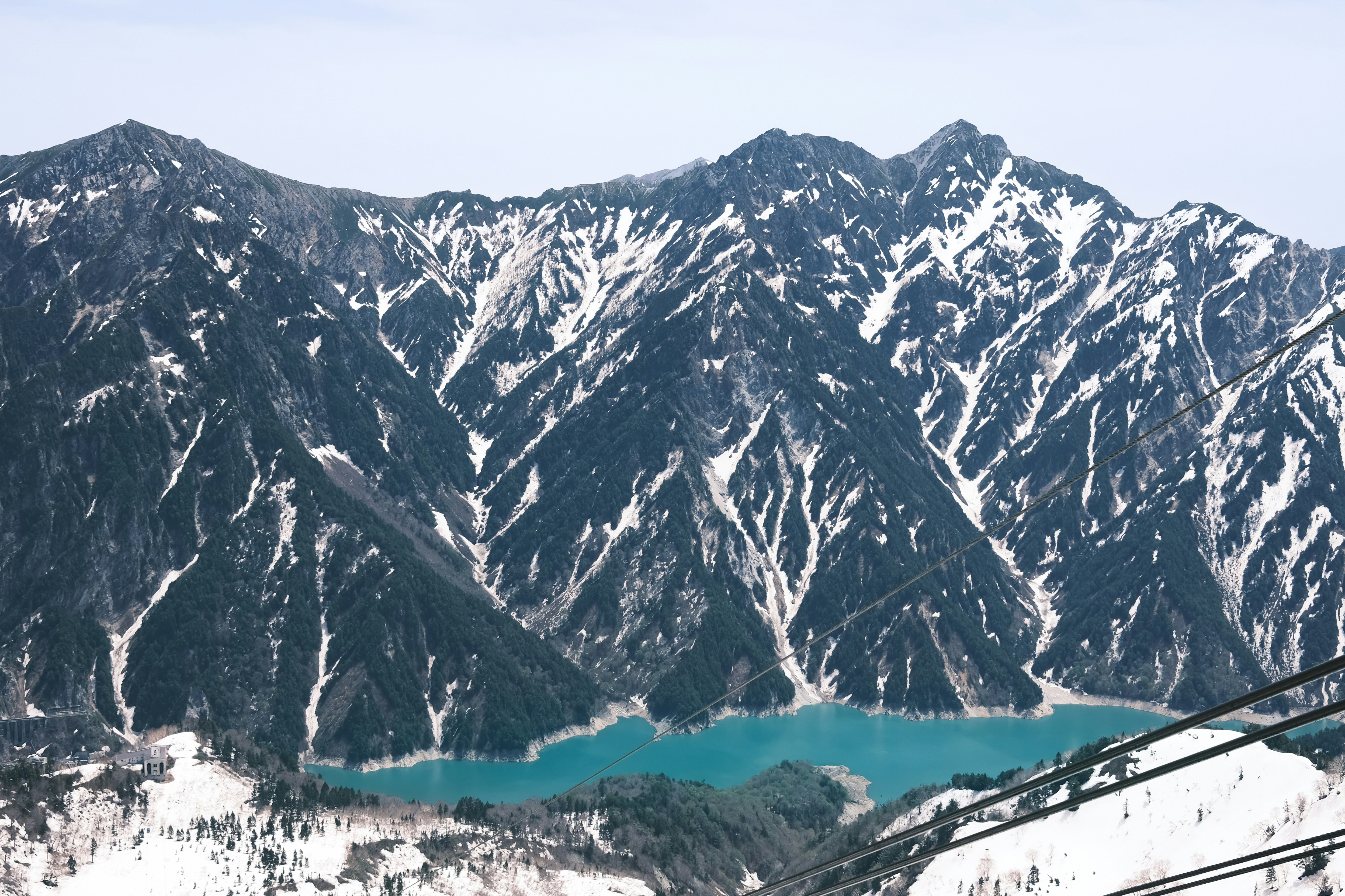 Snow-covered mountains with a turquoise lake below