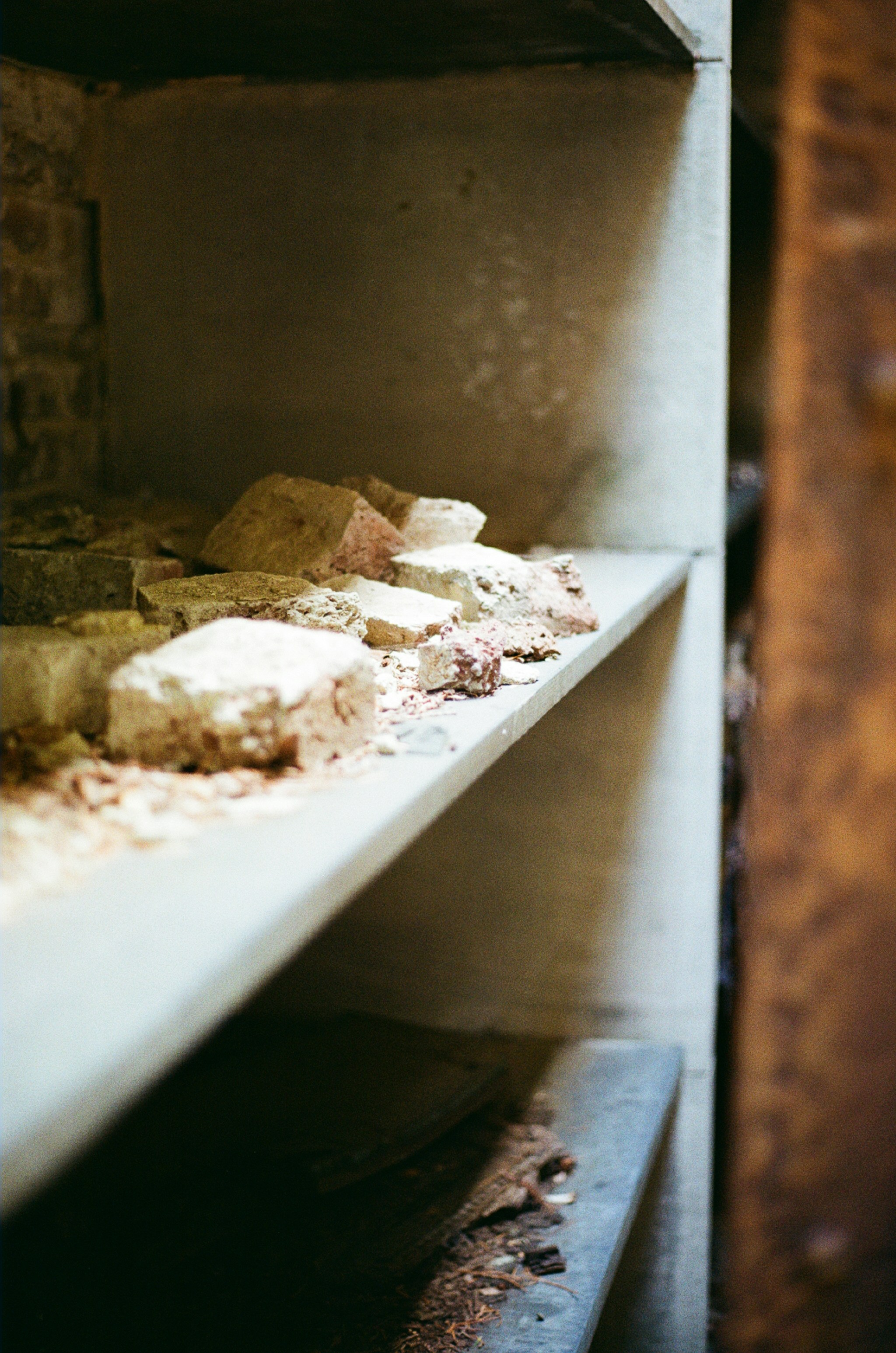 Broken bricks and debris on a dusty shelf