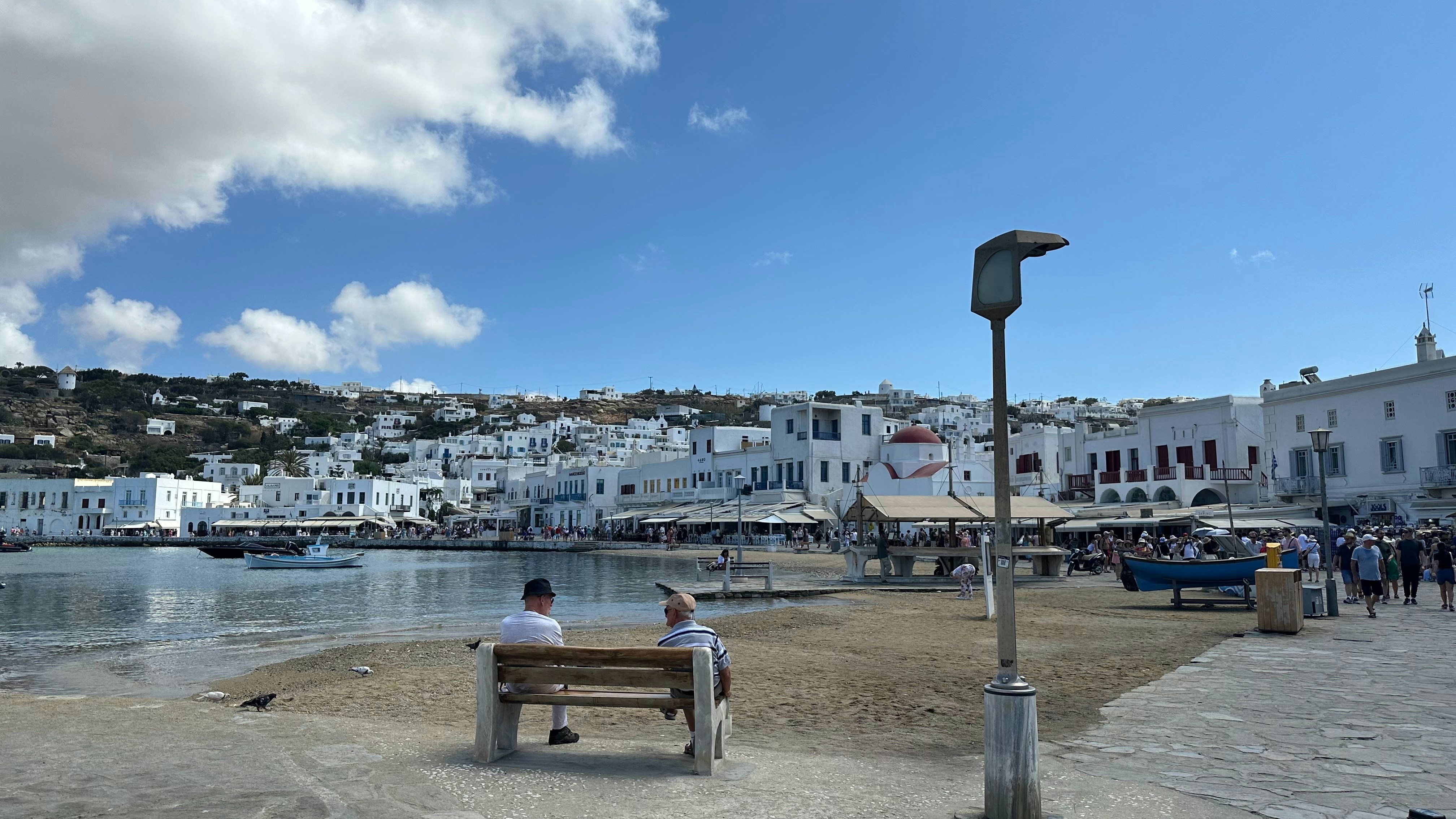 White buildings by the water under a blue sky