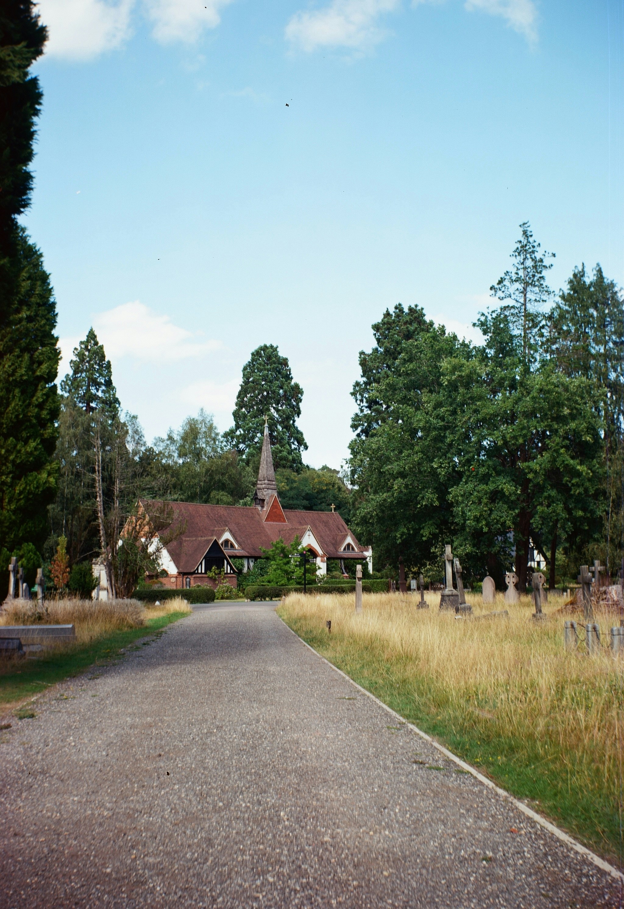 Church and graves in a grassy cemetery