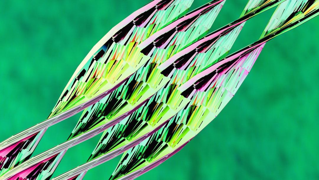 Three abstract colorful leaves against green background