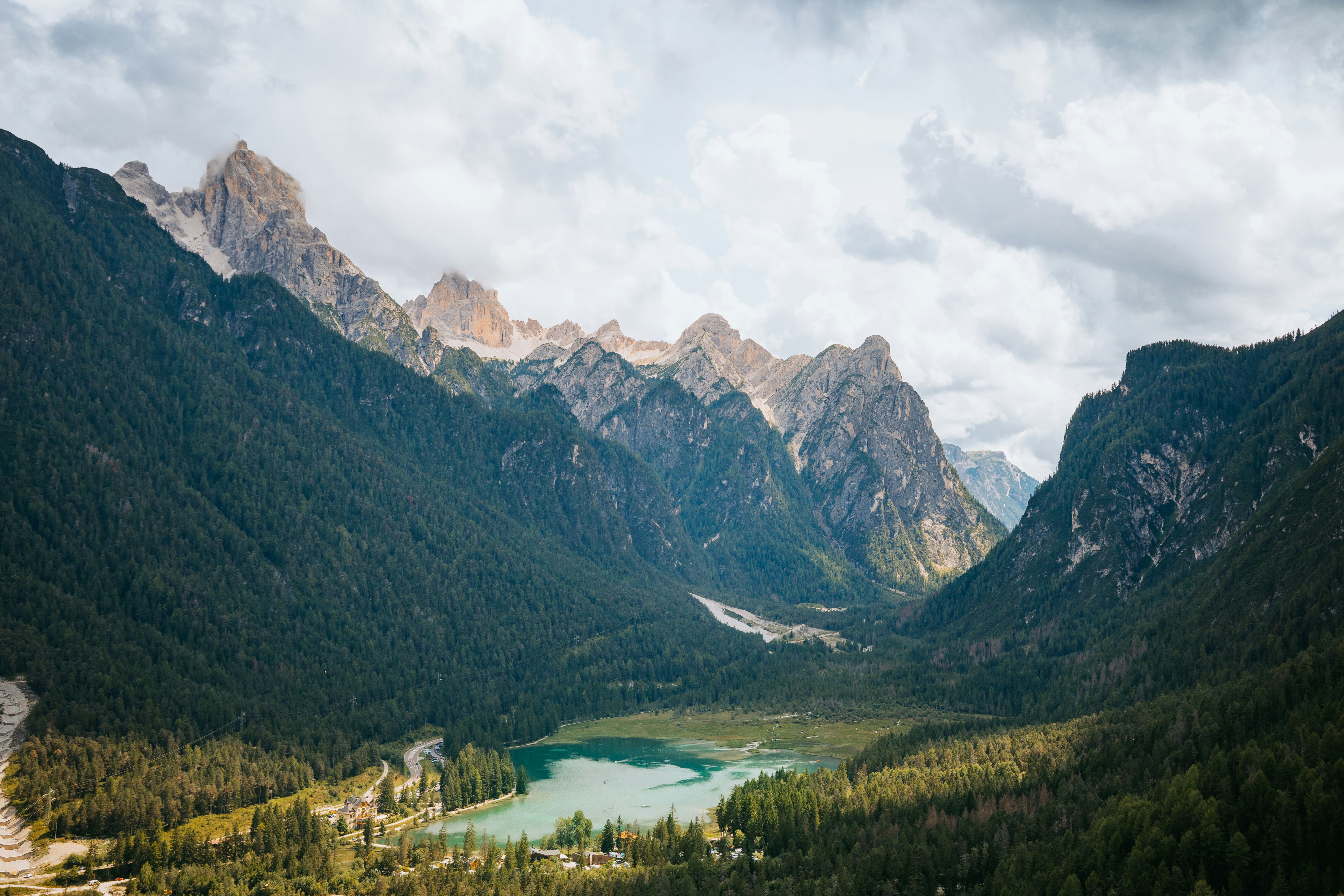 Majestic mountains rise above a serene valley landscape.