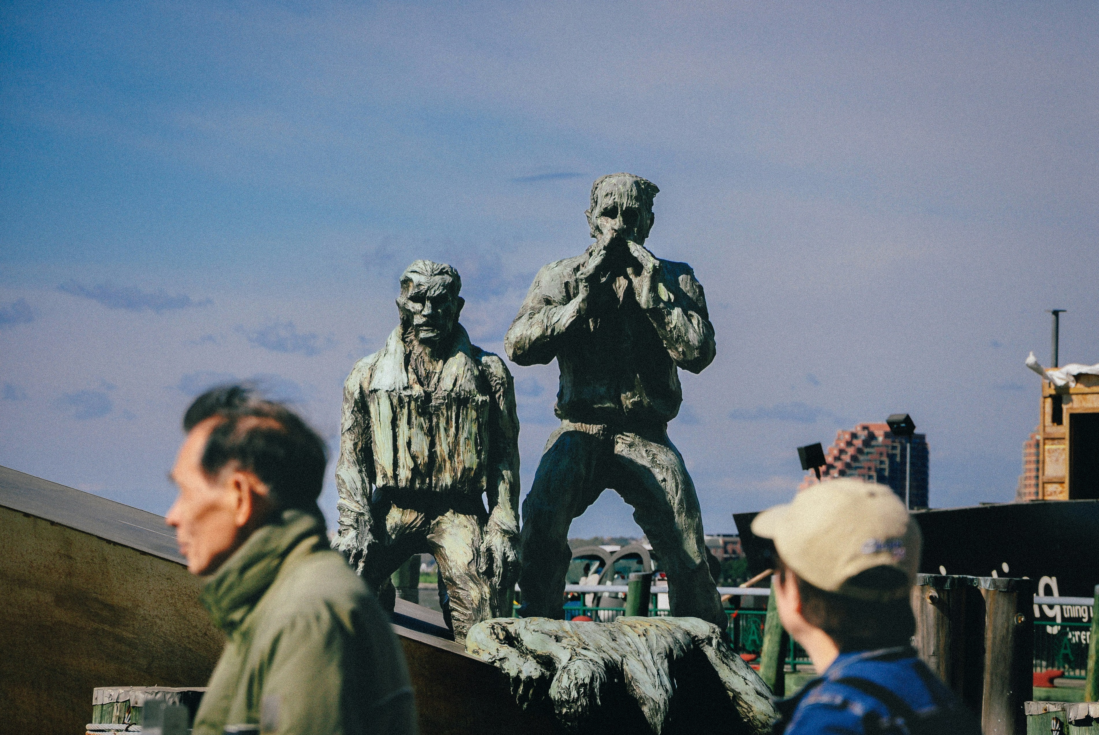 Soldiers in uniform stand on a vehicle.