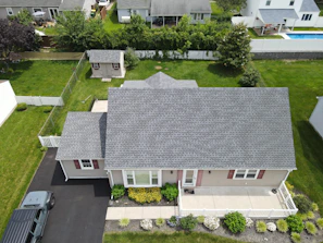 Aerial view of a suburban house with a grey roof