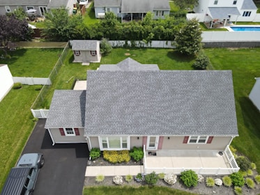 Aerial view of a suburban house with a grey roof