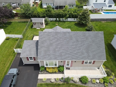 Aerial view of a suburban house with a grey roof