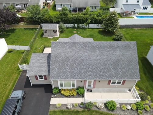 Aerial view of a suburban house with a grey roof