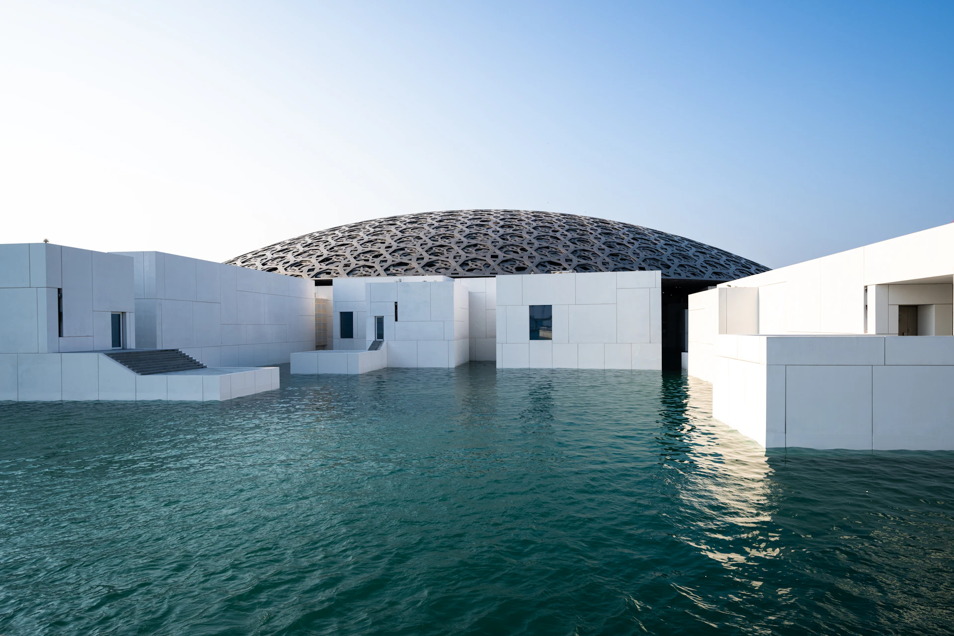 A modern domed building standing over the water