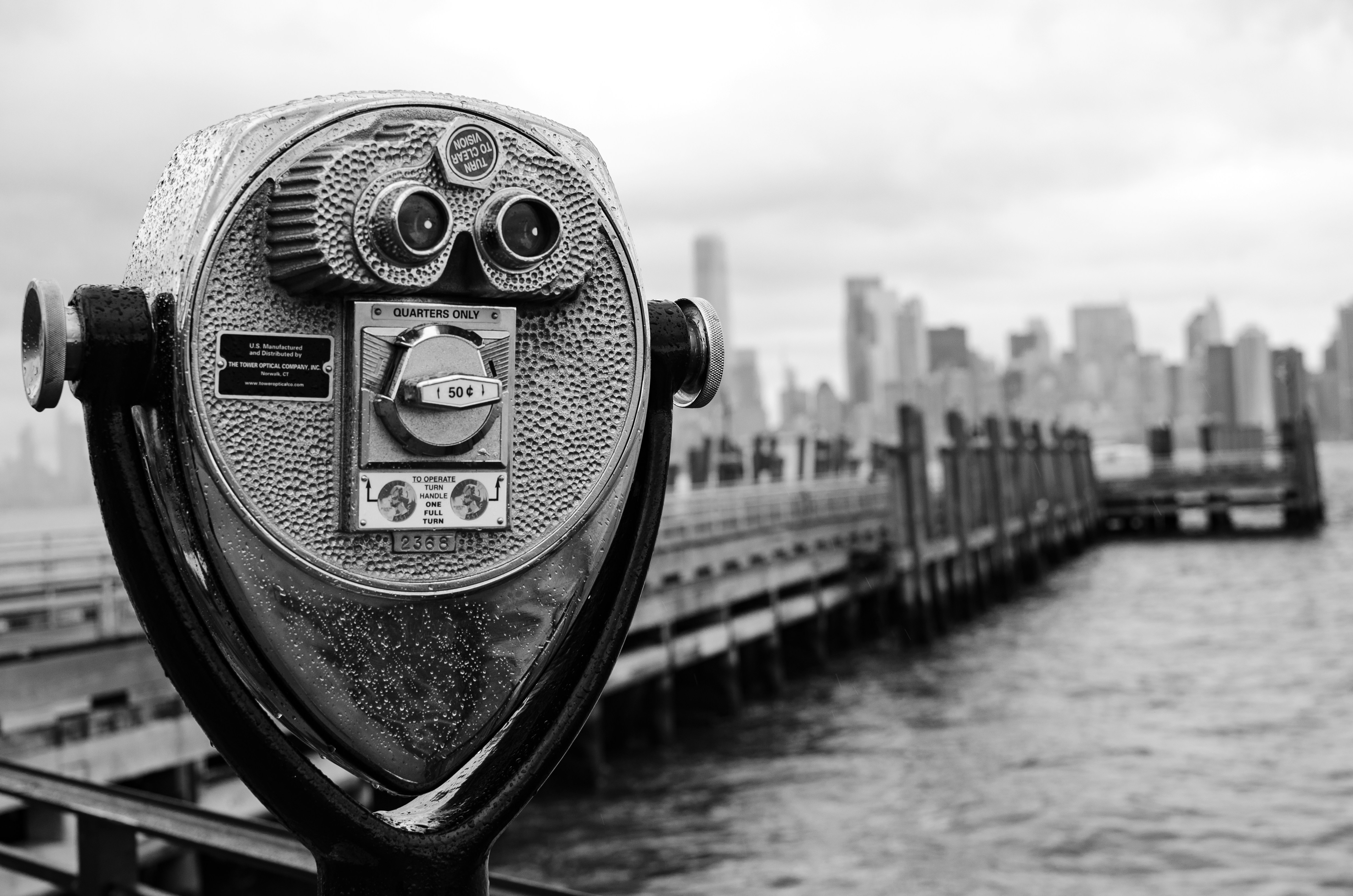 Binoculars on pier overlooking city skyline