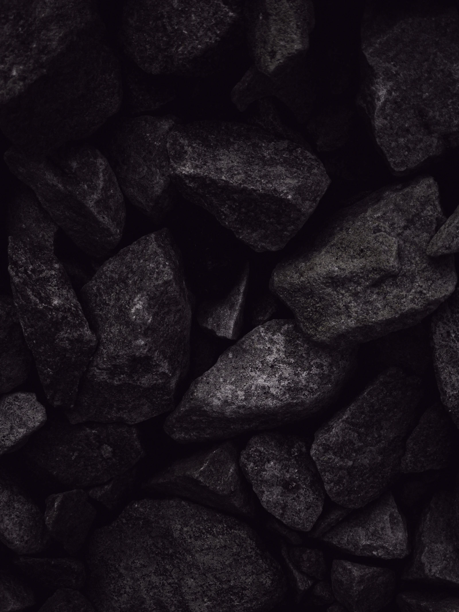 Pile of dark hardwood charcoal pieces