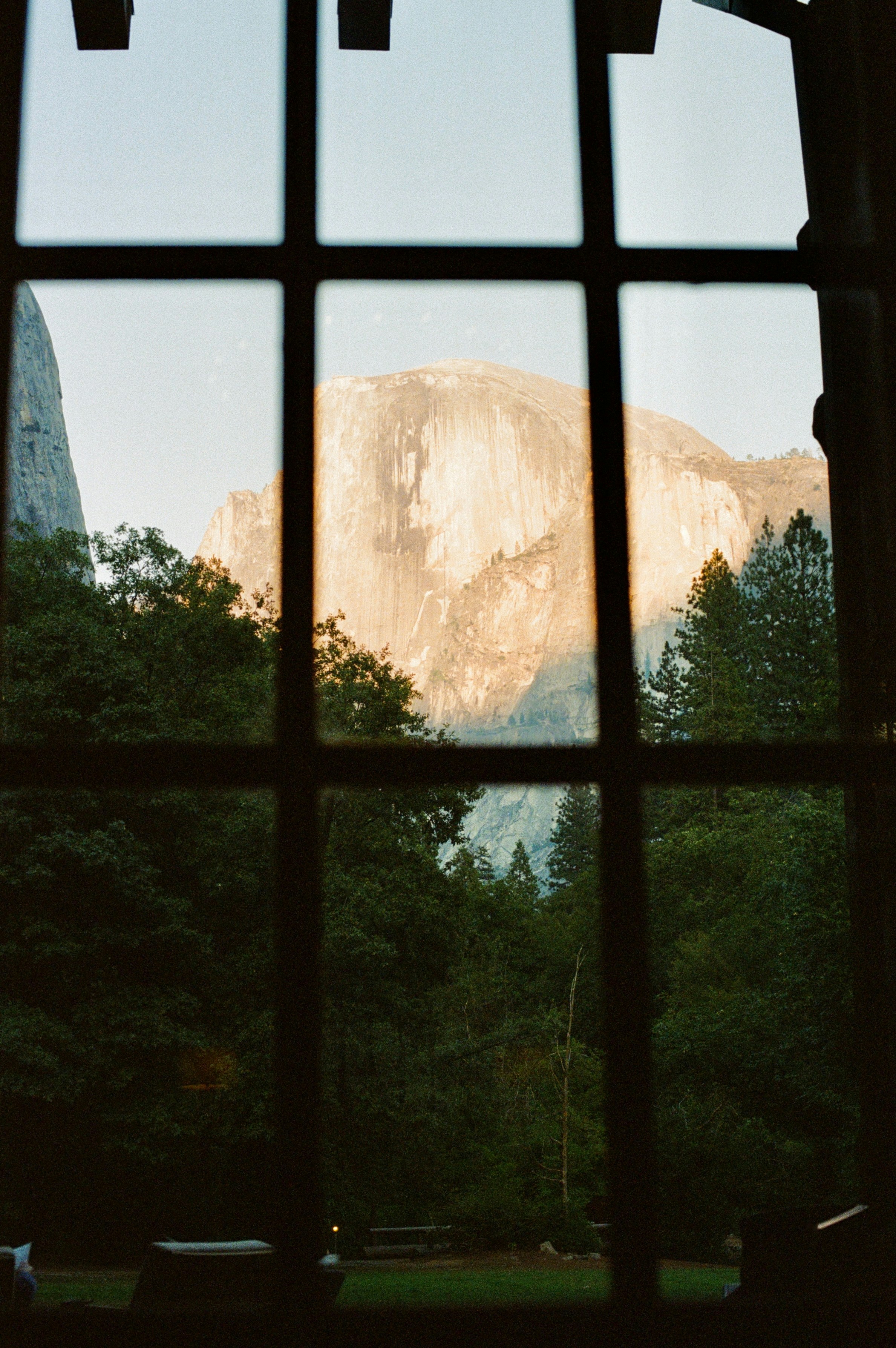 Mountain peak seen through a window at sunset