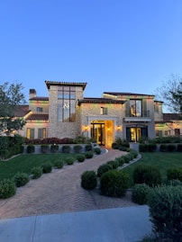 Modern luxury home with manicured lawn and driveway