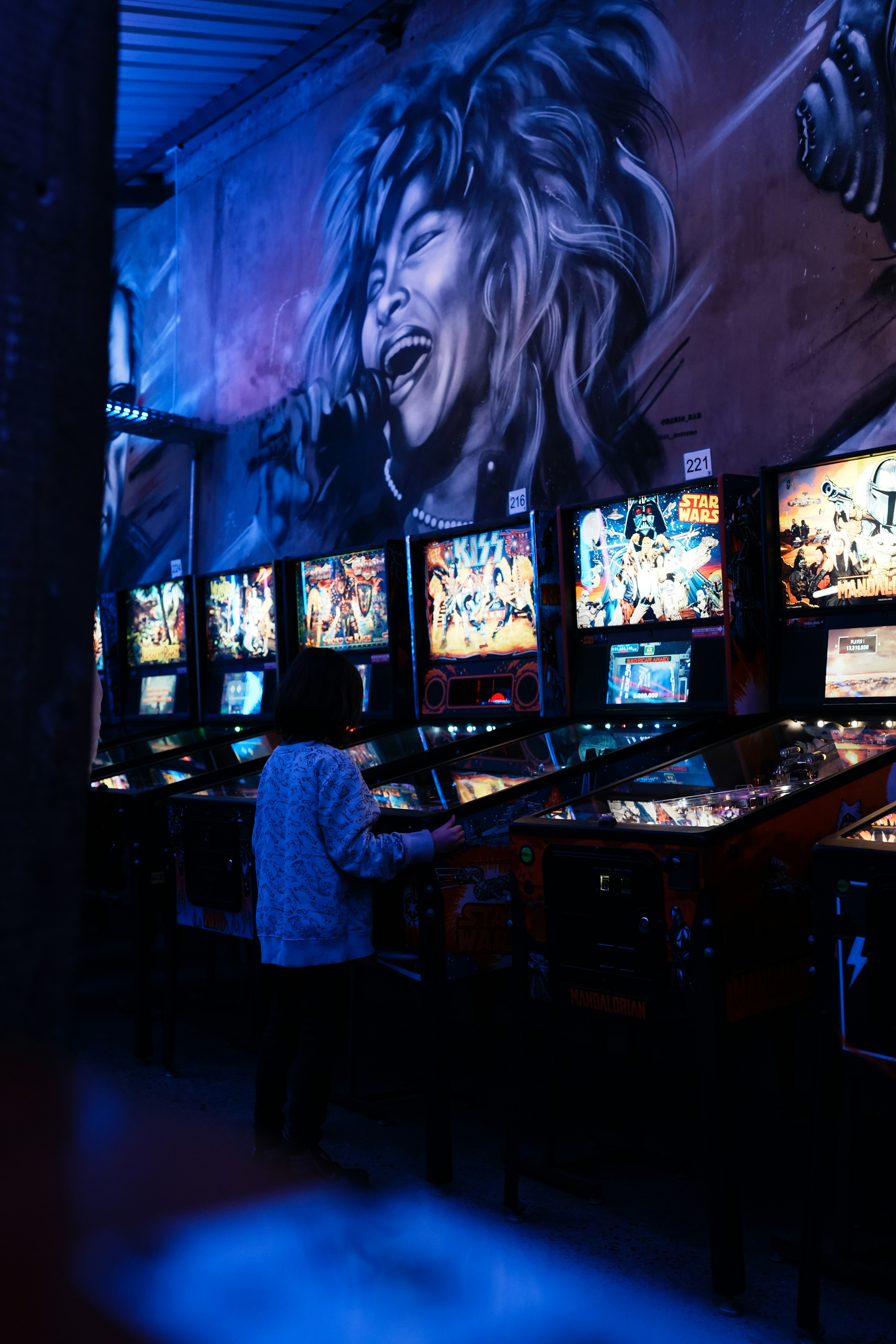Person watching multiple screens in a dimly lit room