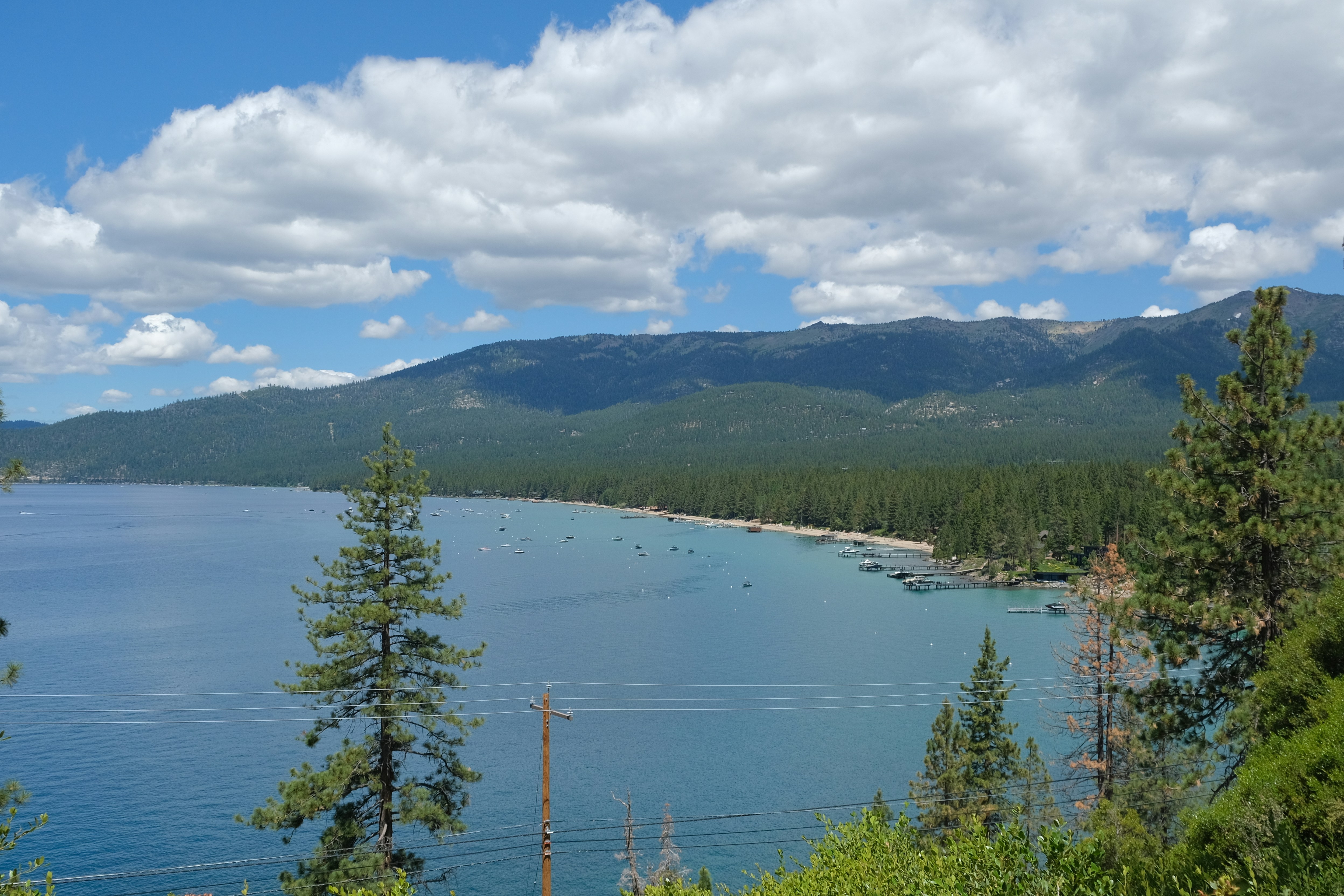 Scenic lake surrounded by pine trees and mountains