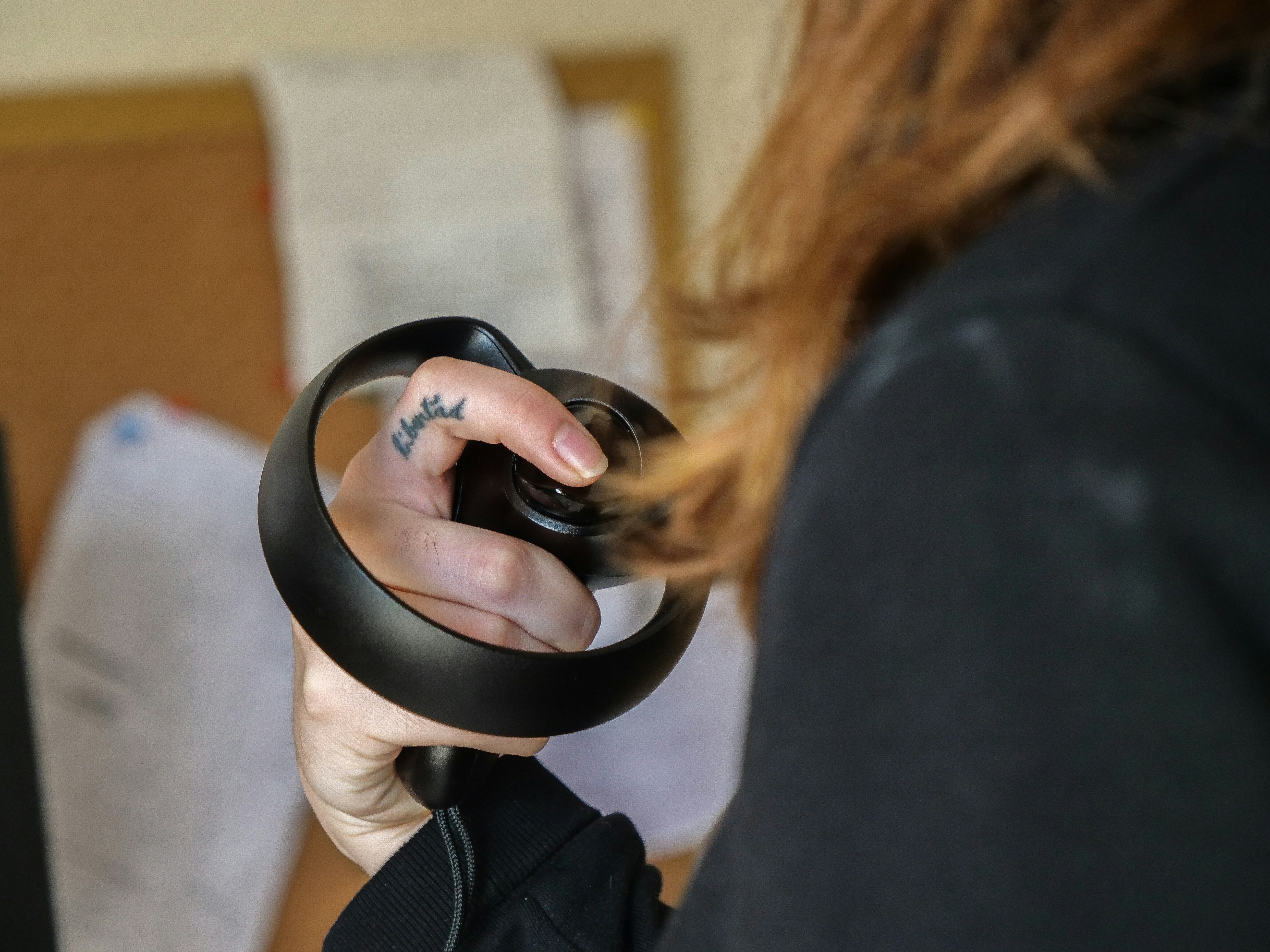 Close-up of a person holding a virtual reality controller