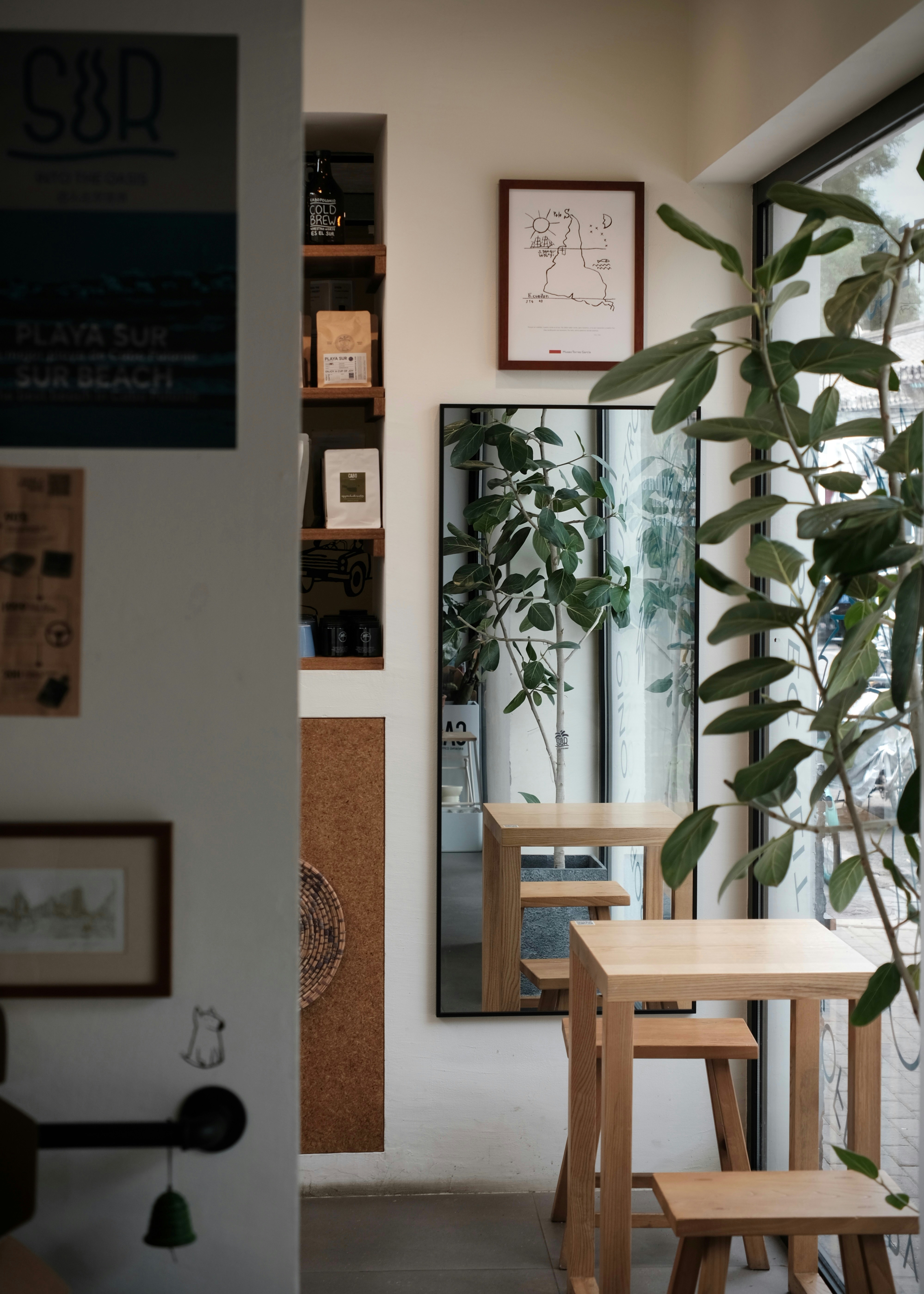 Cozy cafe interior with wooden tables and plants