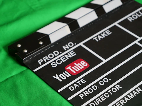 Clapperboard with youtube logo on green screen.