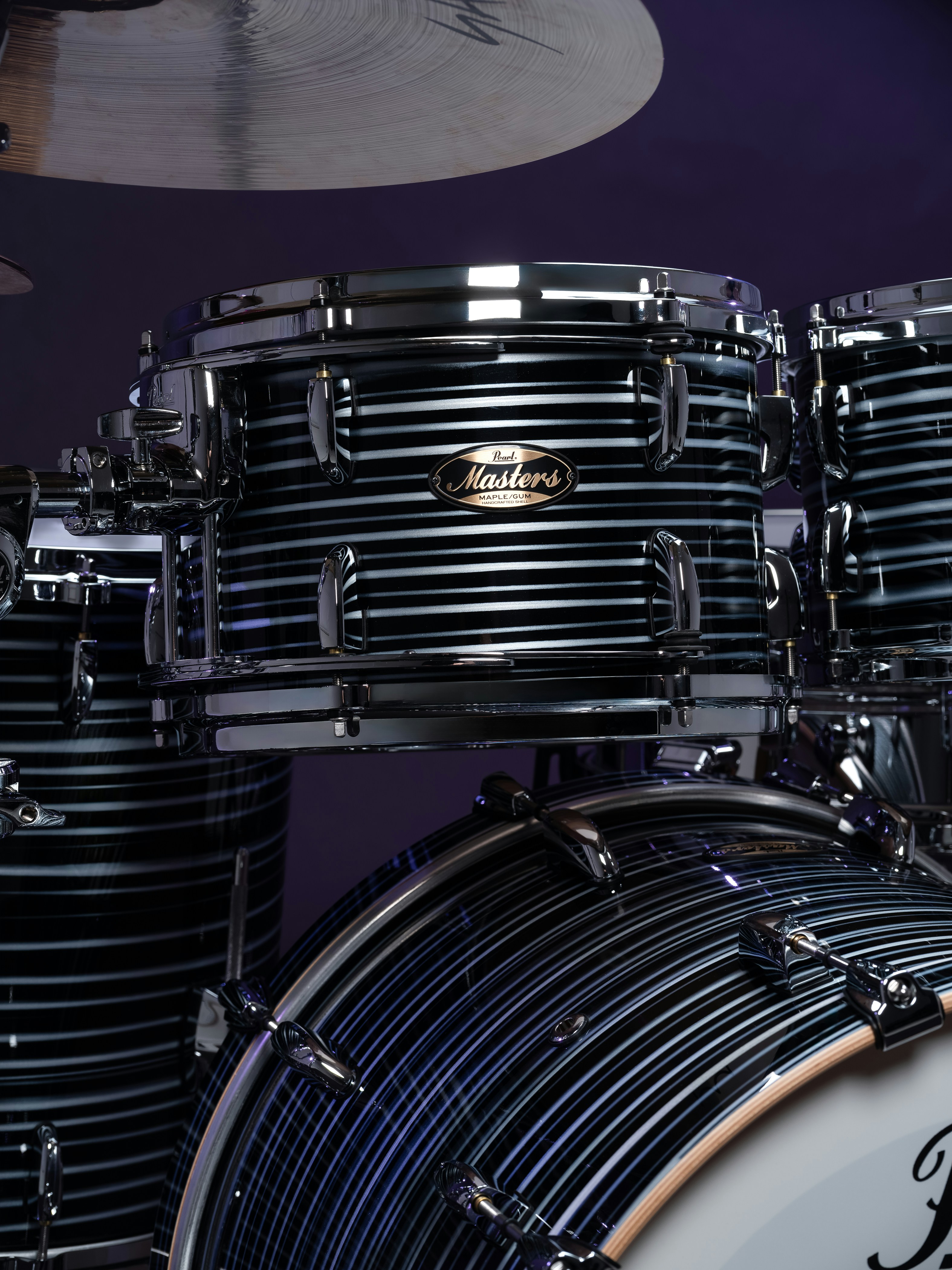 A detailed view of a drum kit with striped finish