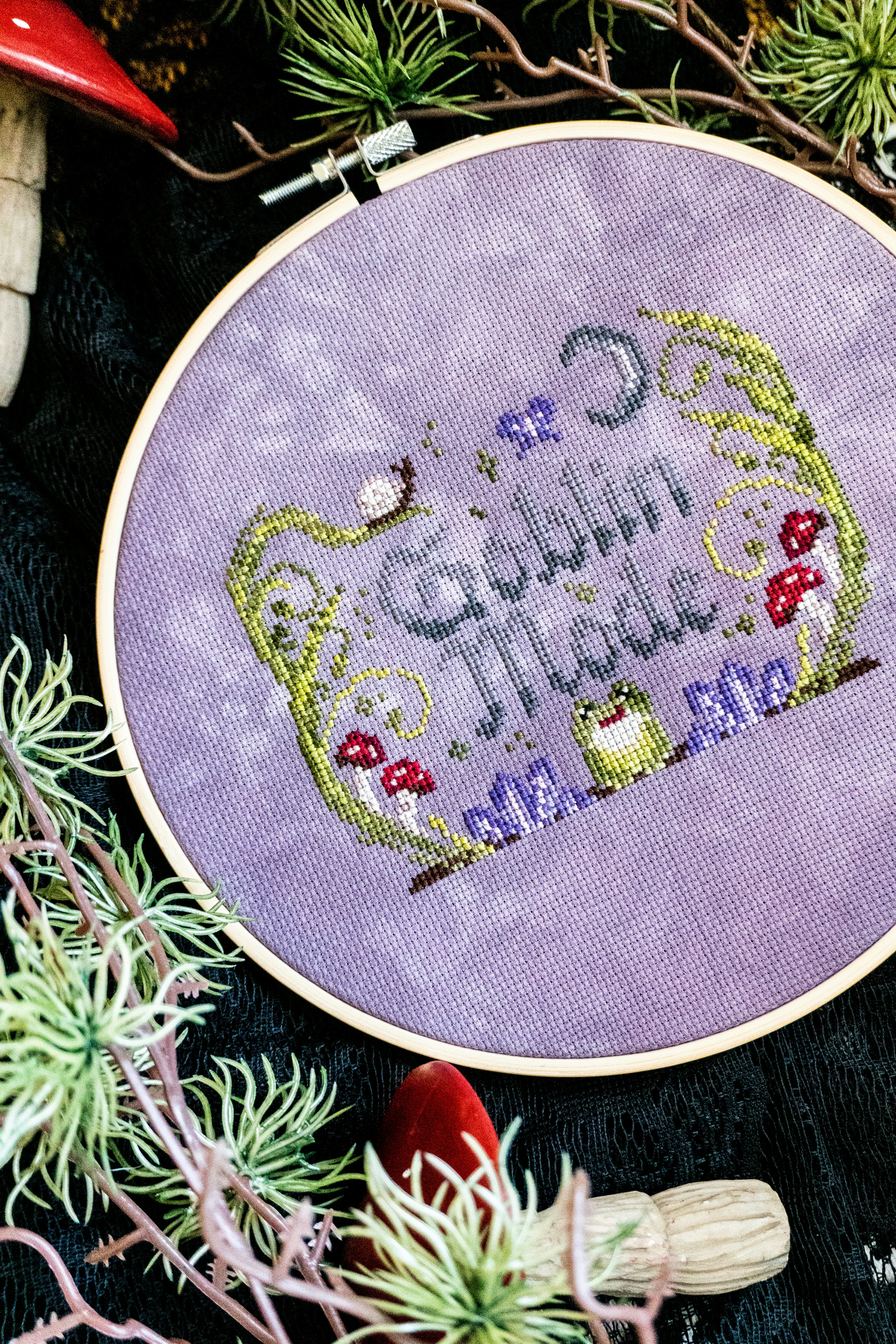 Cross-stitch hoop with "goblin mode" and whimsical elements.