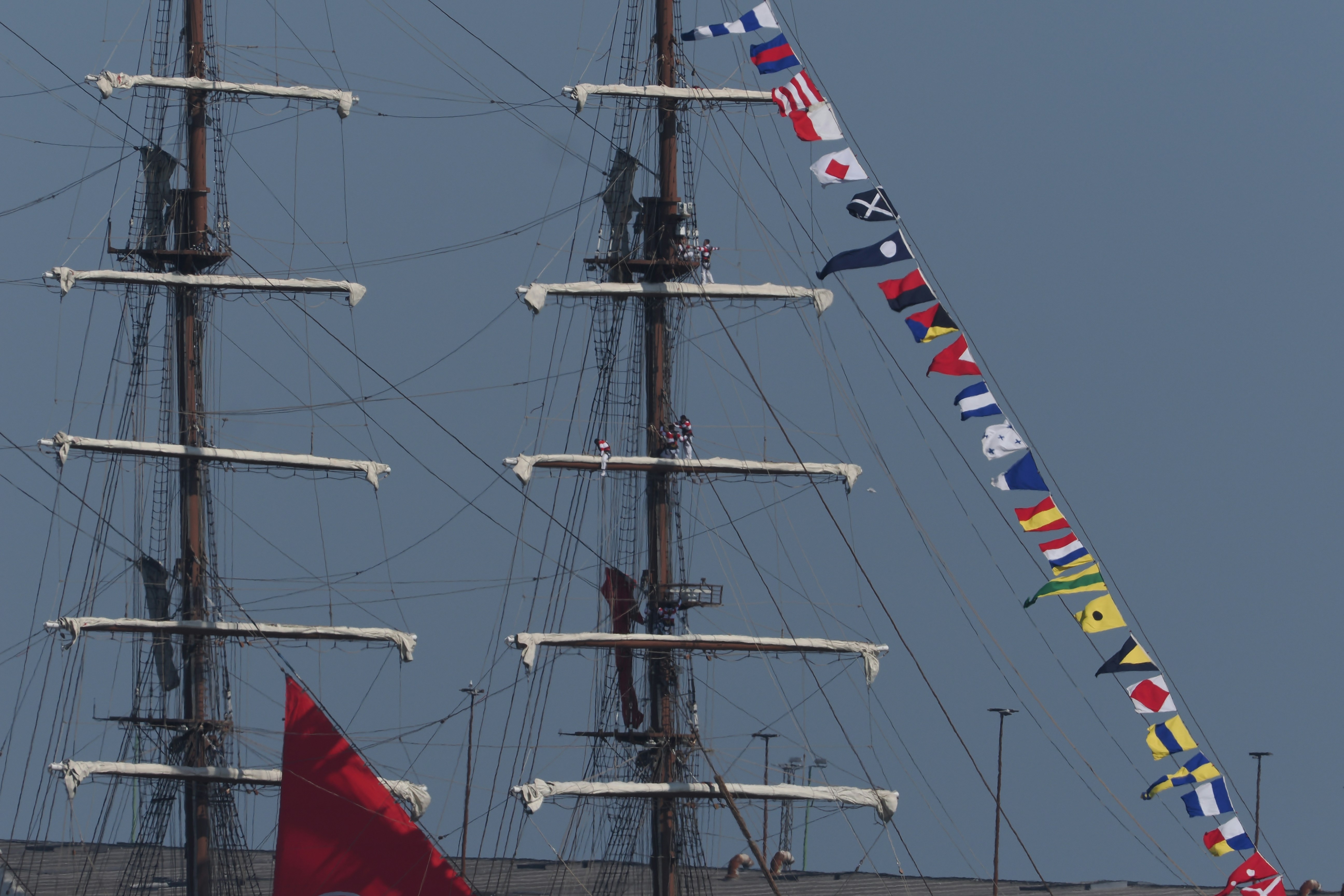 Tall ship masts with nautical flags and red sail photo – Free Human ...