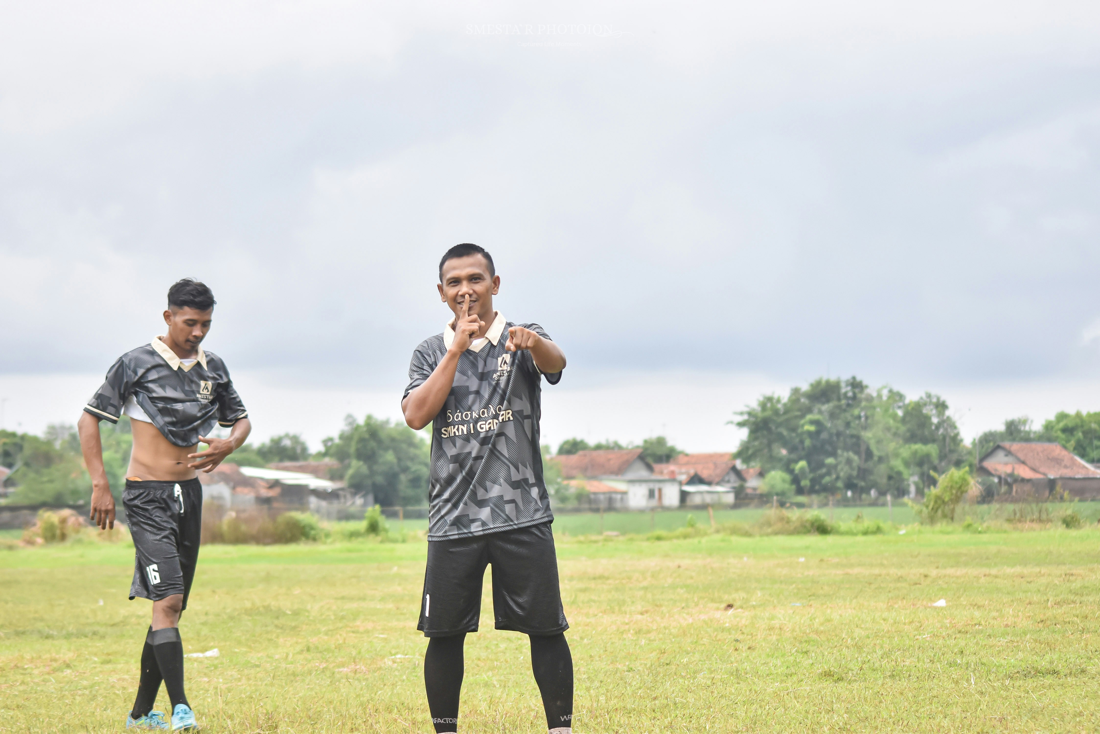 Two men in soccer uniforms on a field