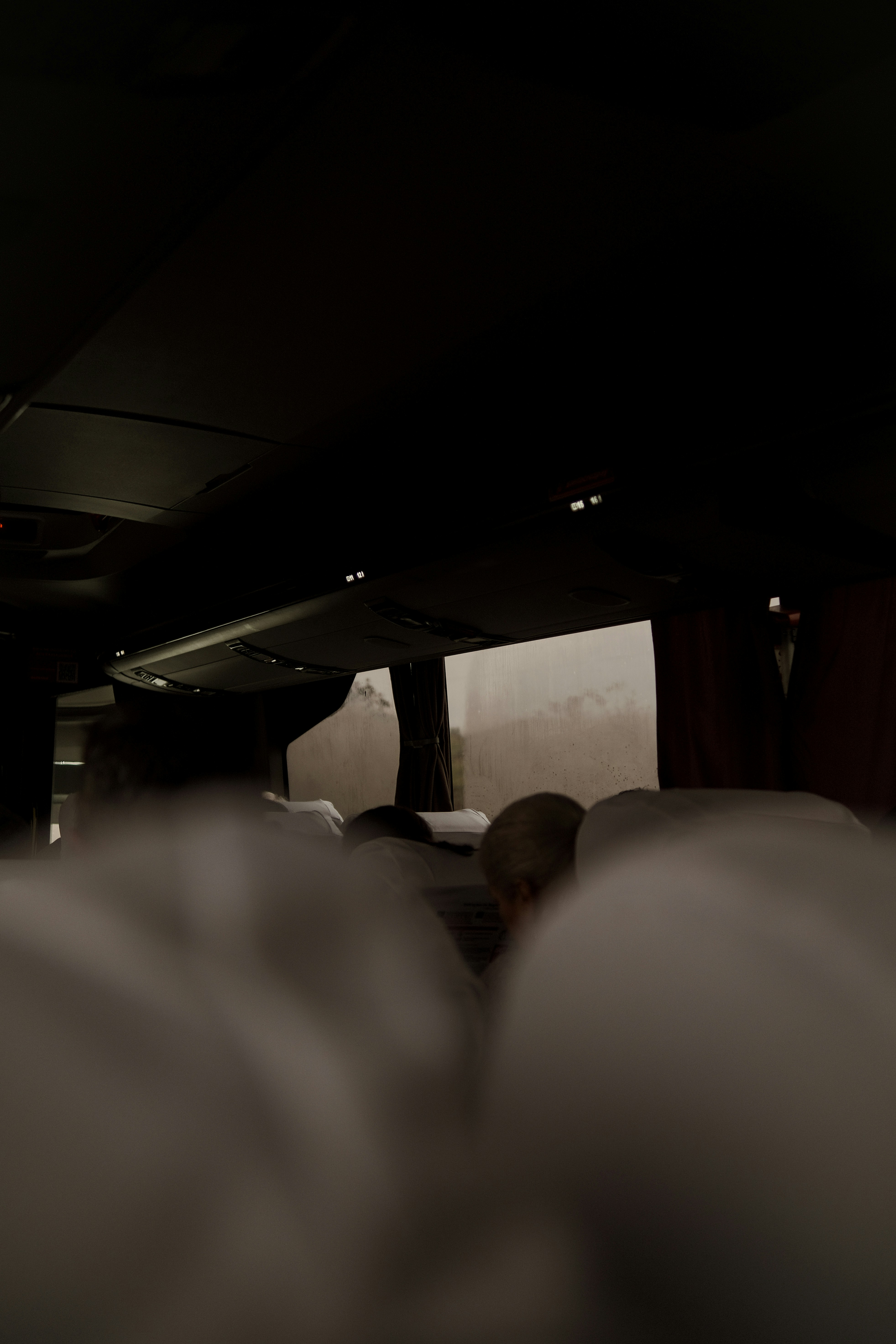 Passenger sleeping on a bus at night