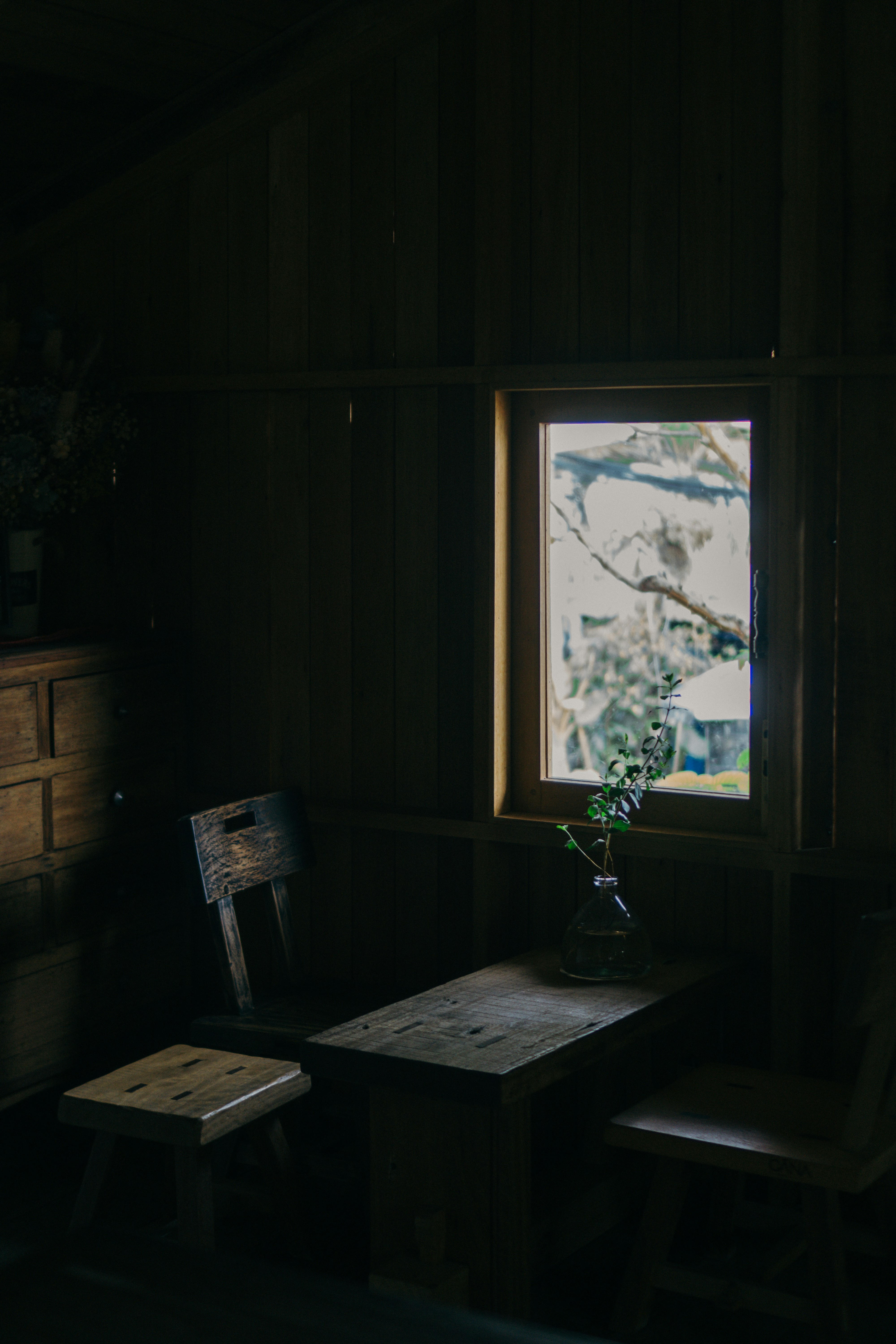 Wooden table and chairs by a window