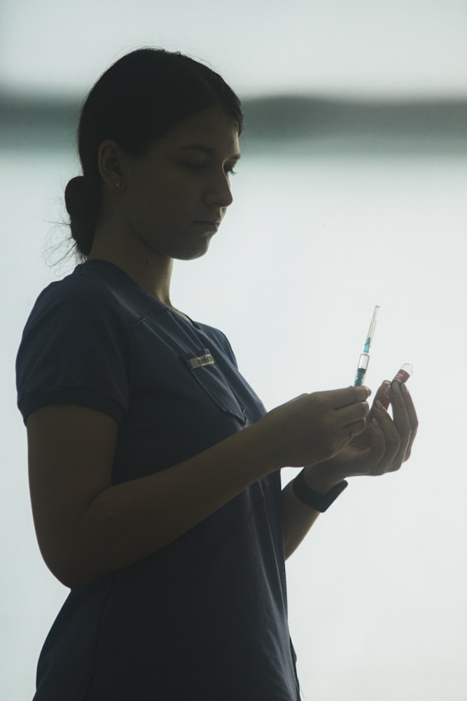 A nurse preparing a dose of the Qdenga dengue vaccine