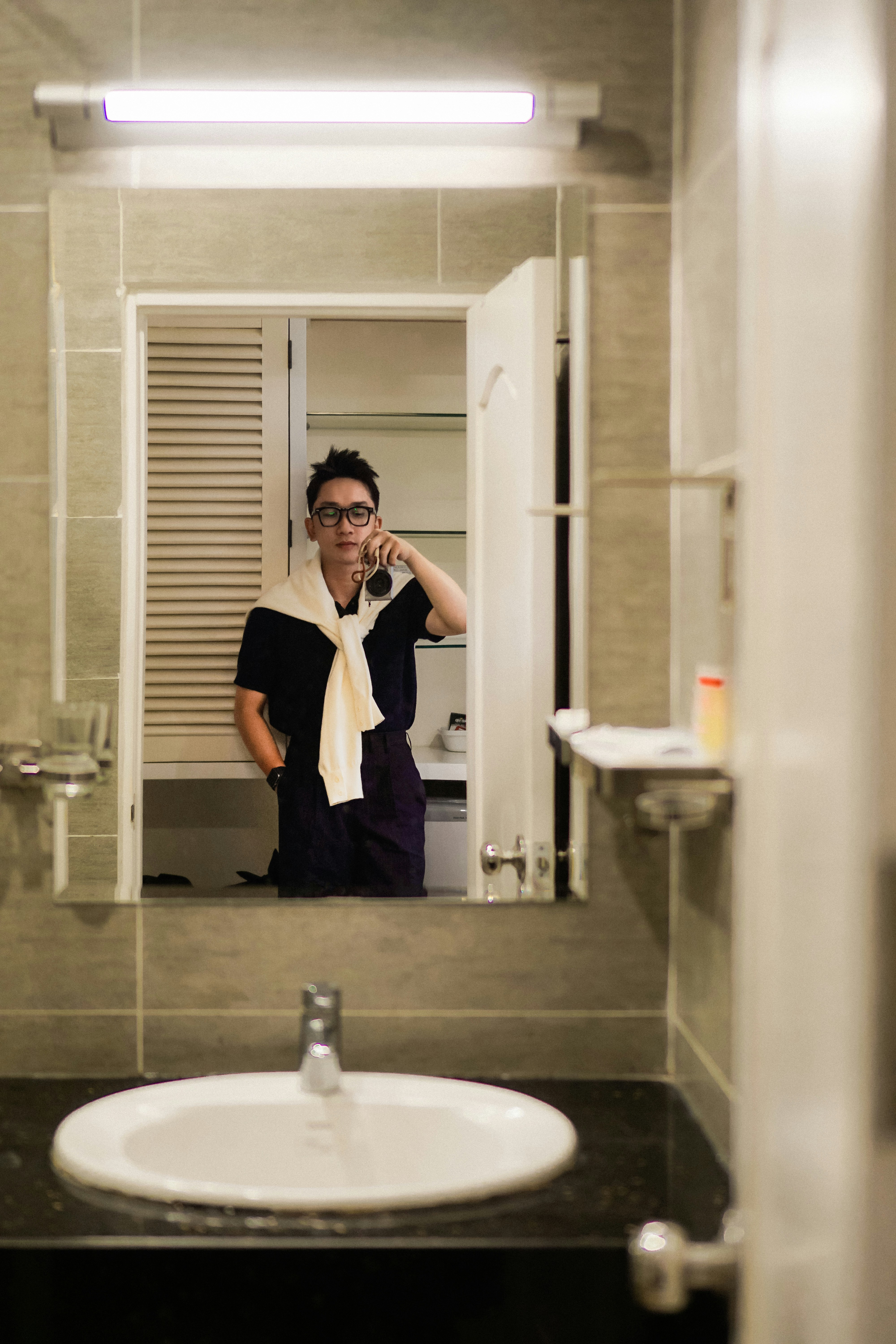 Man talking on phone in bathroom mirror