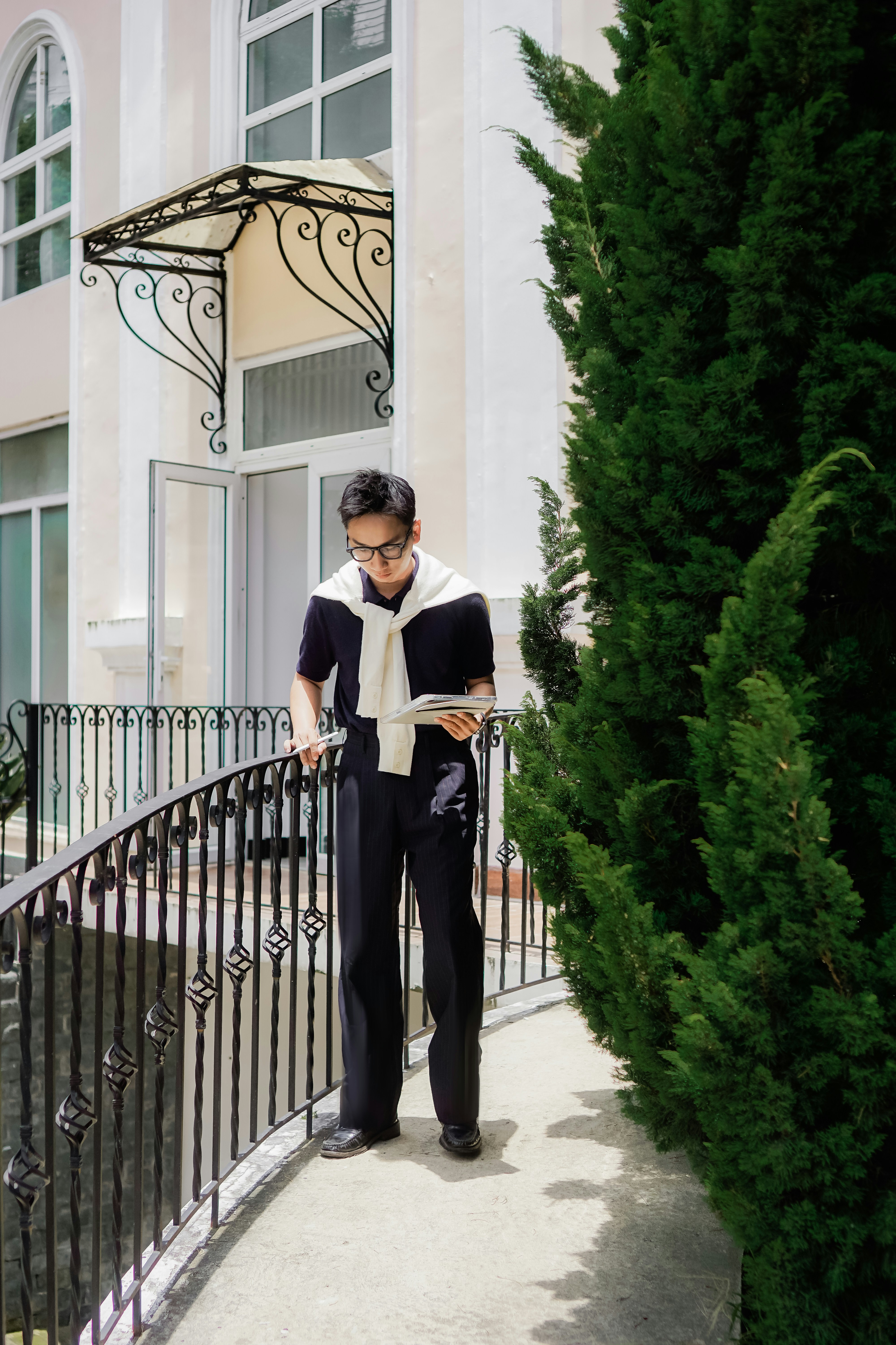 Man in black reading a magazine outdoors