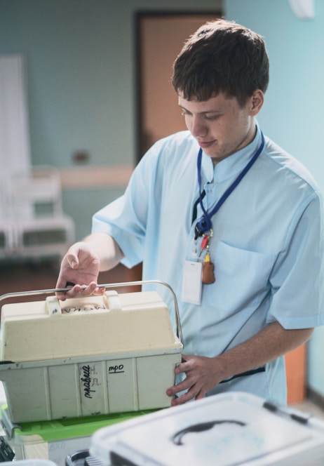 Young man in medical uniform holding a medical case