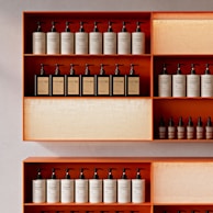 Bottles of toiletries neatly arranged on shelves.