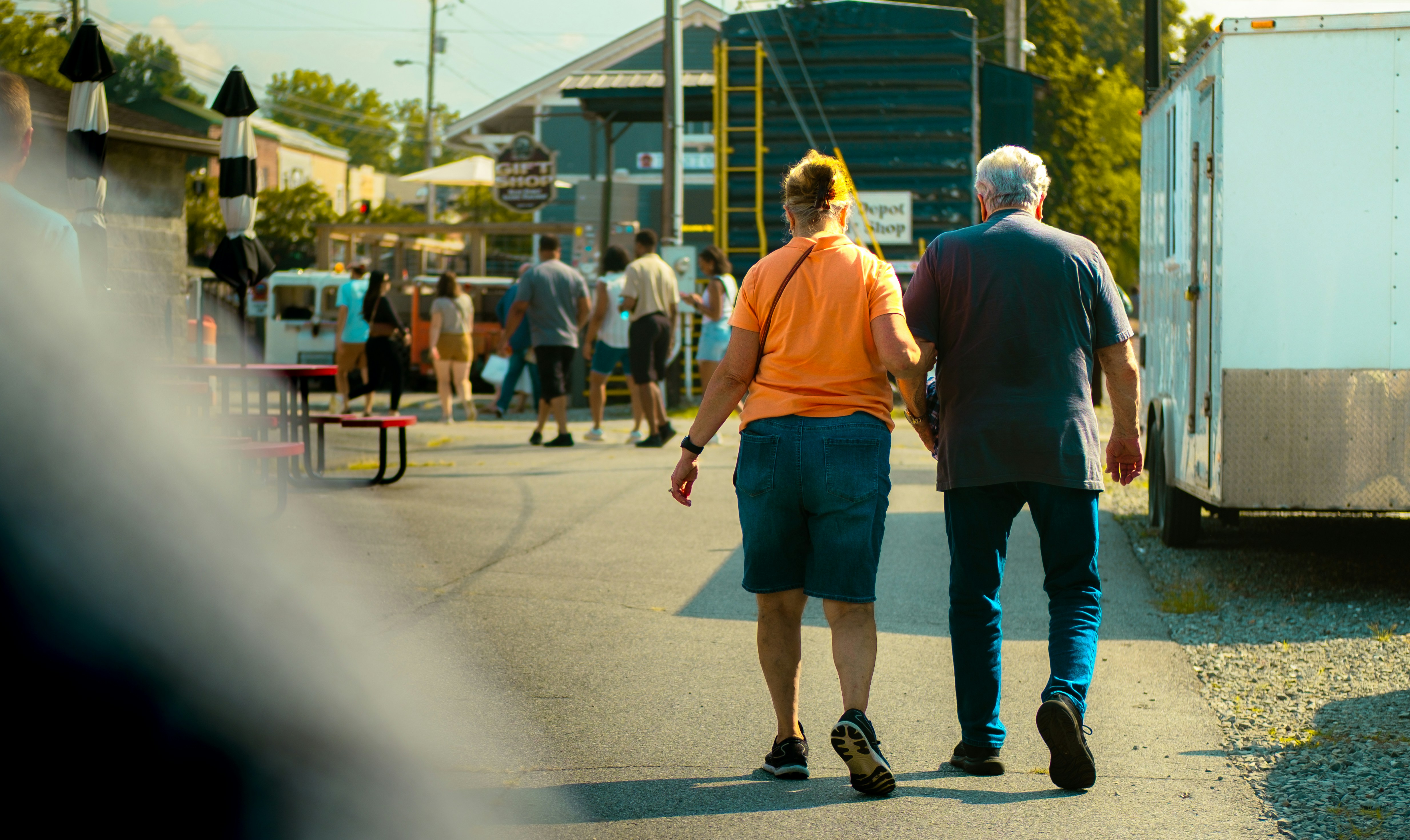 Elderly couple walks down a street together