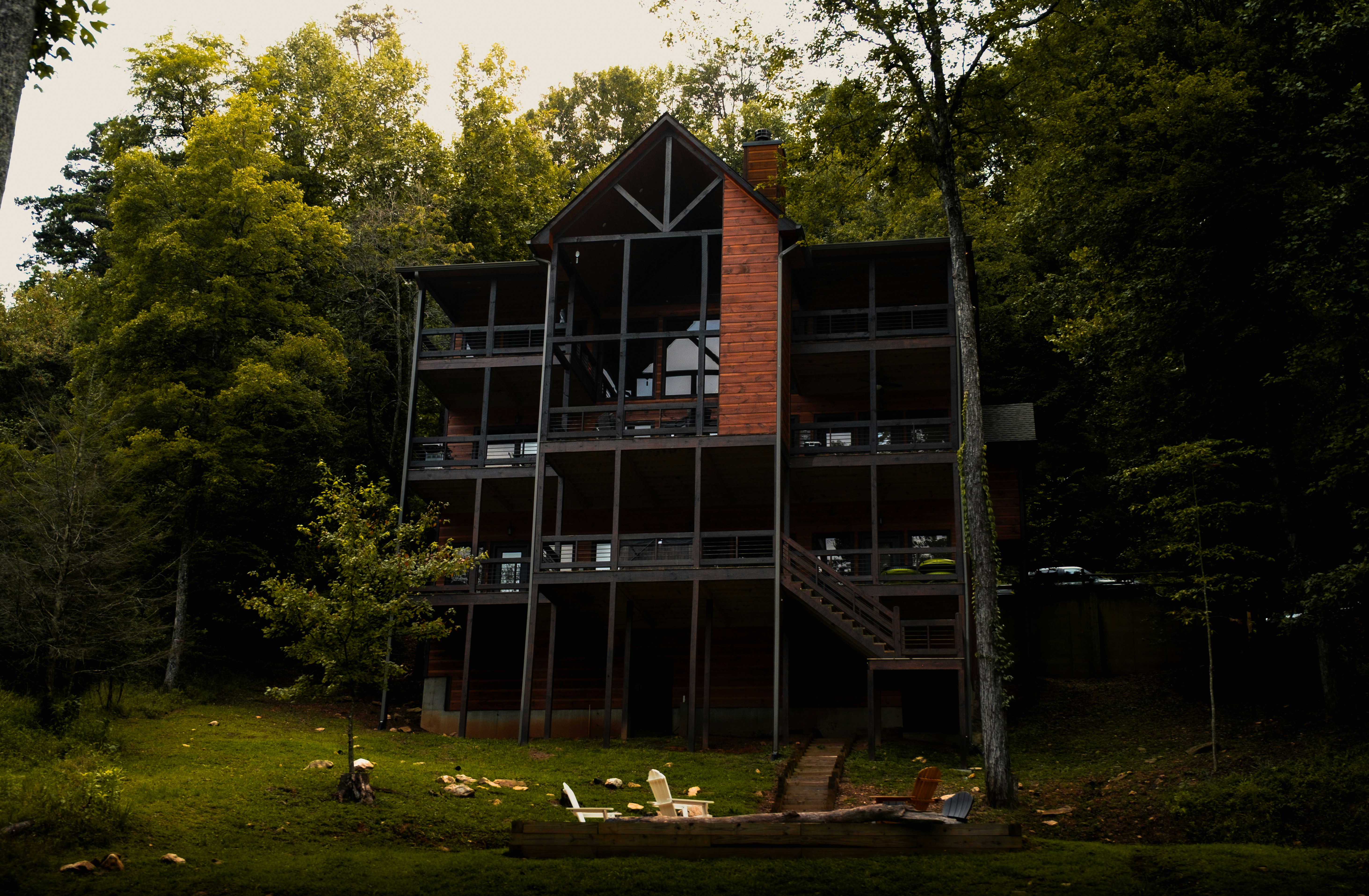Modern house nestled among trees with multiple balconies