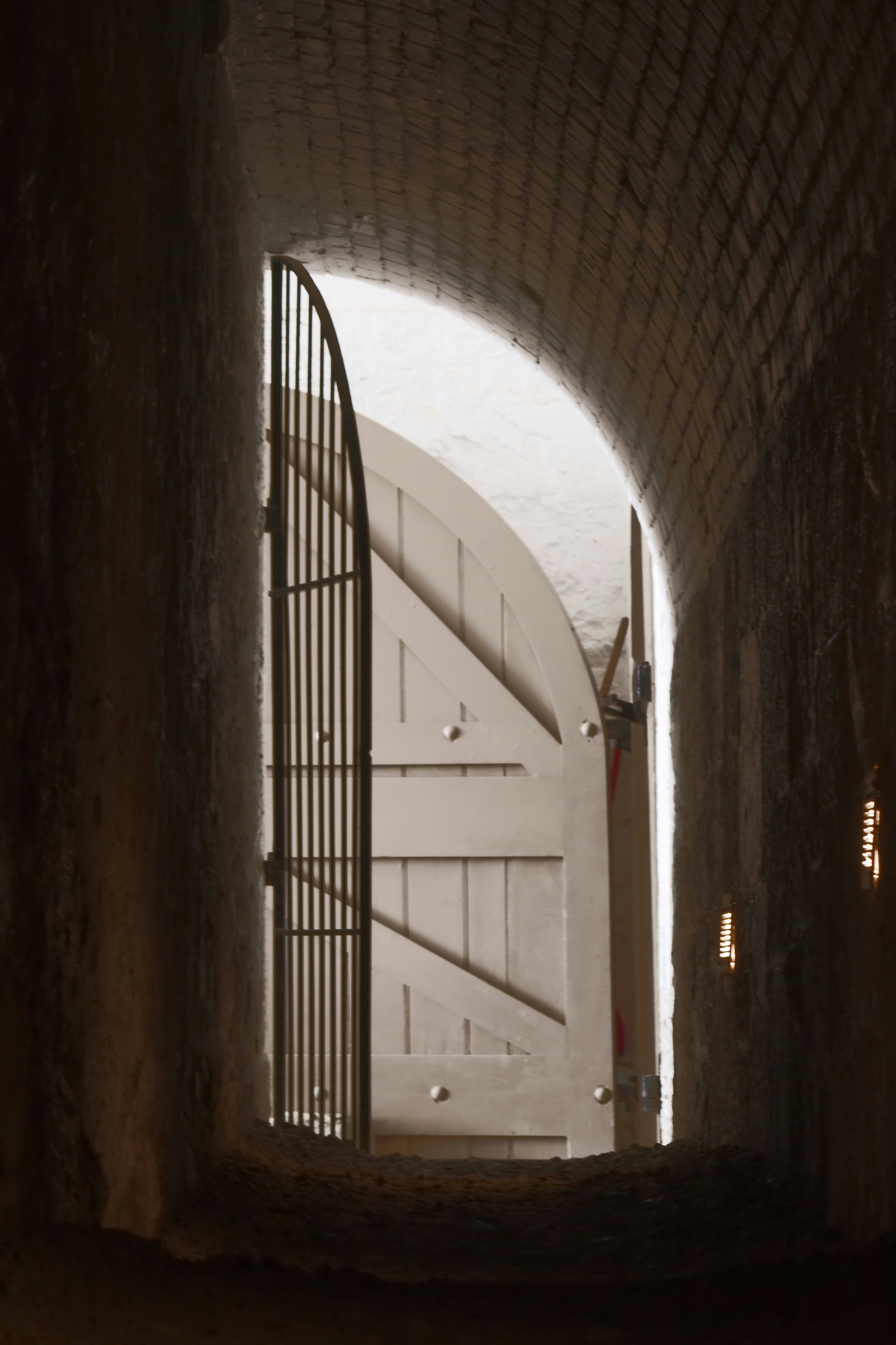 Open doorway with a metal gate and wooden doors