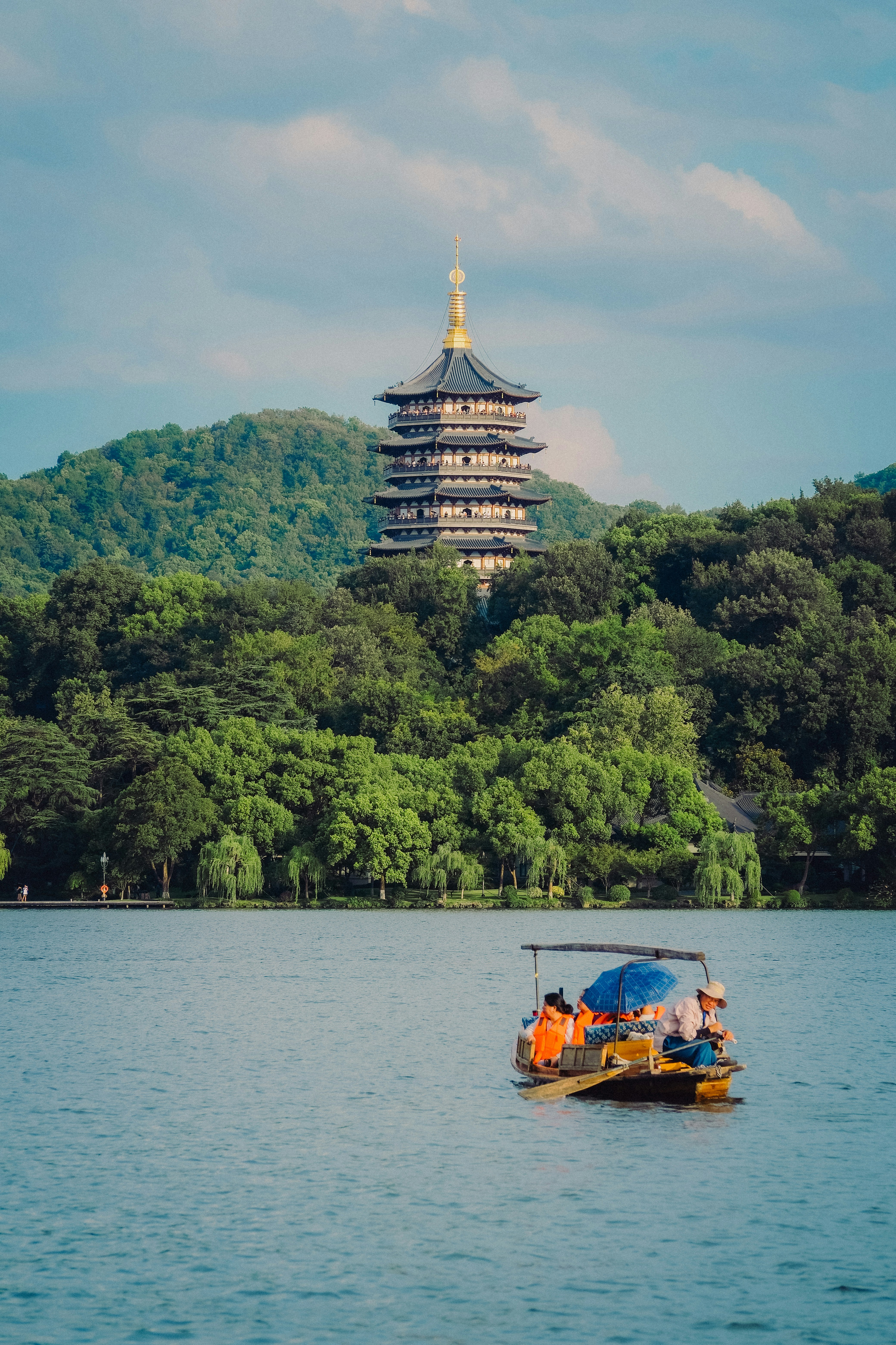 Boat on a lake with pagoda and trees