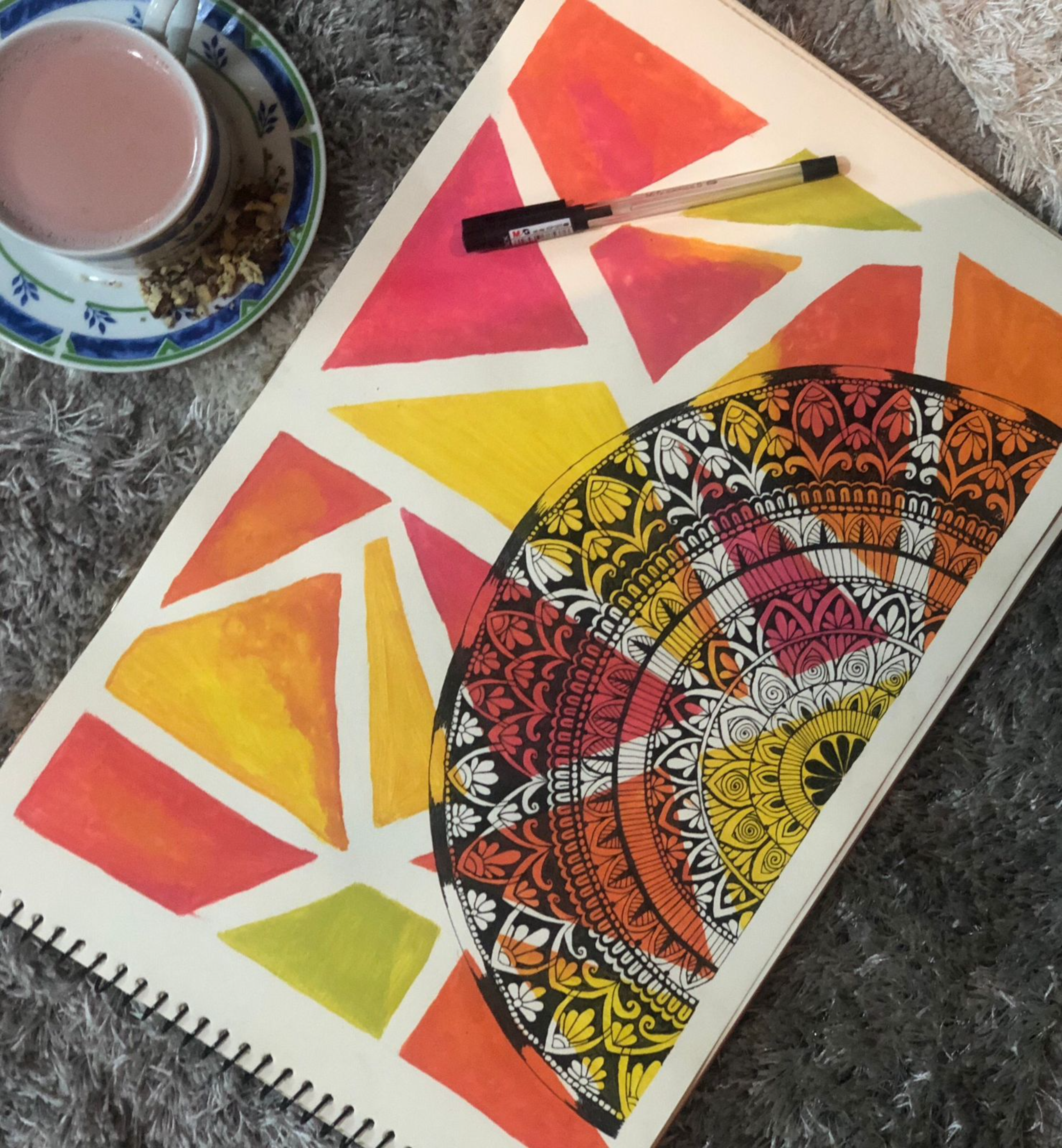 Colorful mandala art with geometric patterns and tea