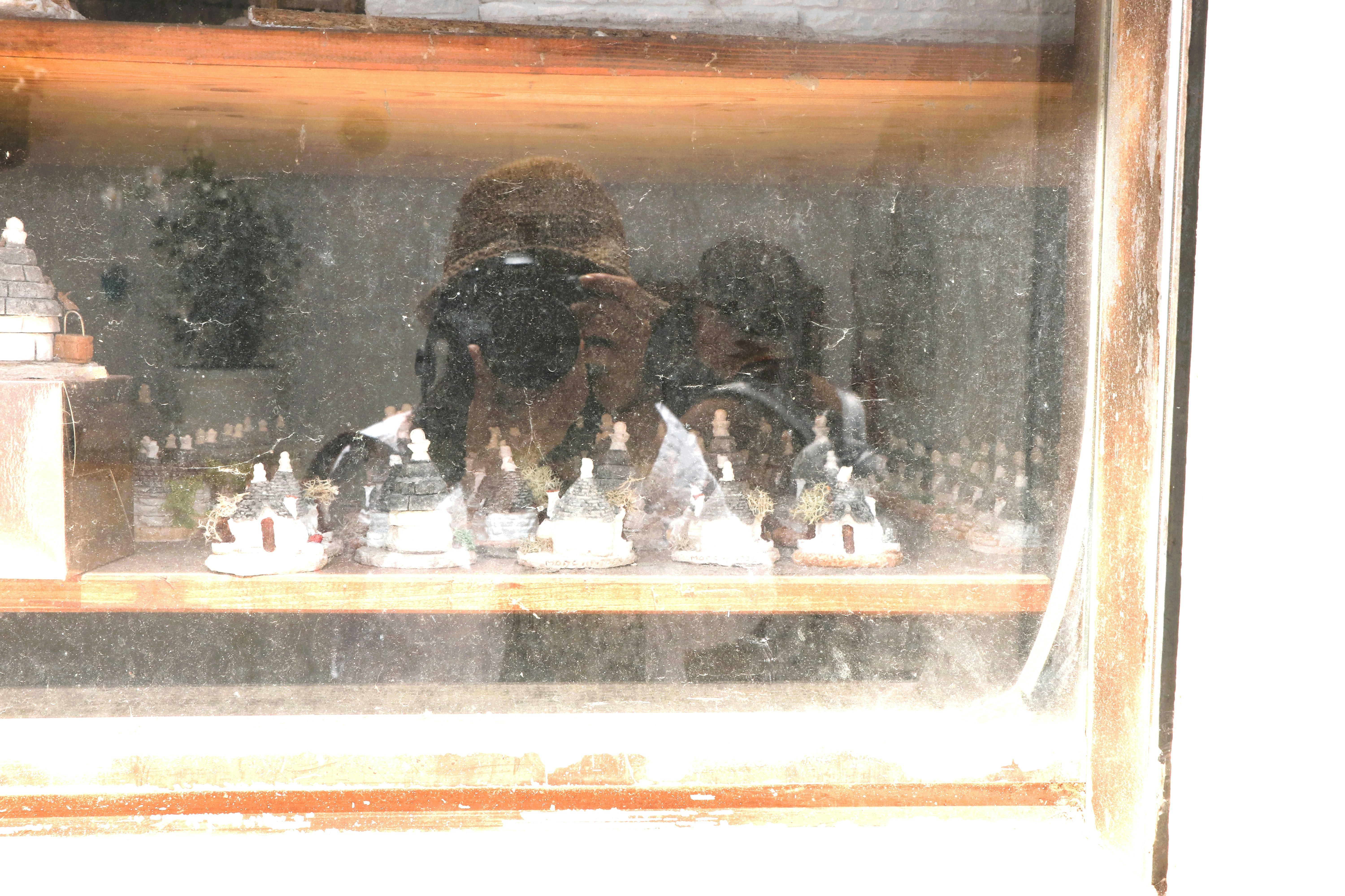 Reflection of a person in a dusty windowpane