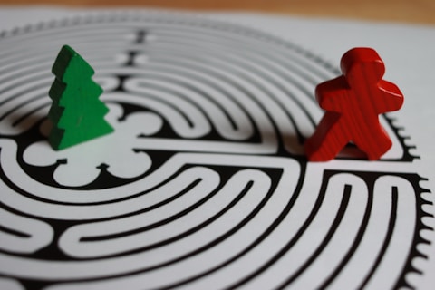 Red figure and green tree on a maze
