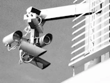 Surveillance cameras mounted on a building exterior.
