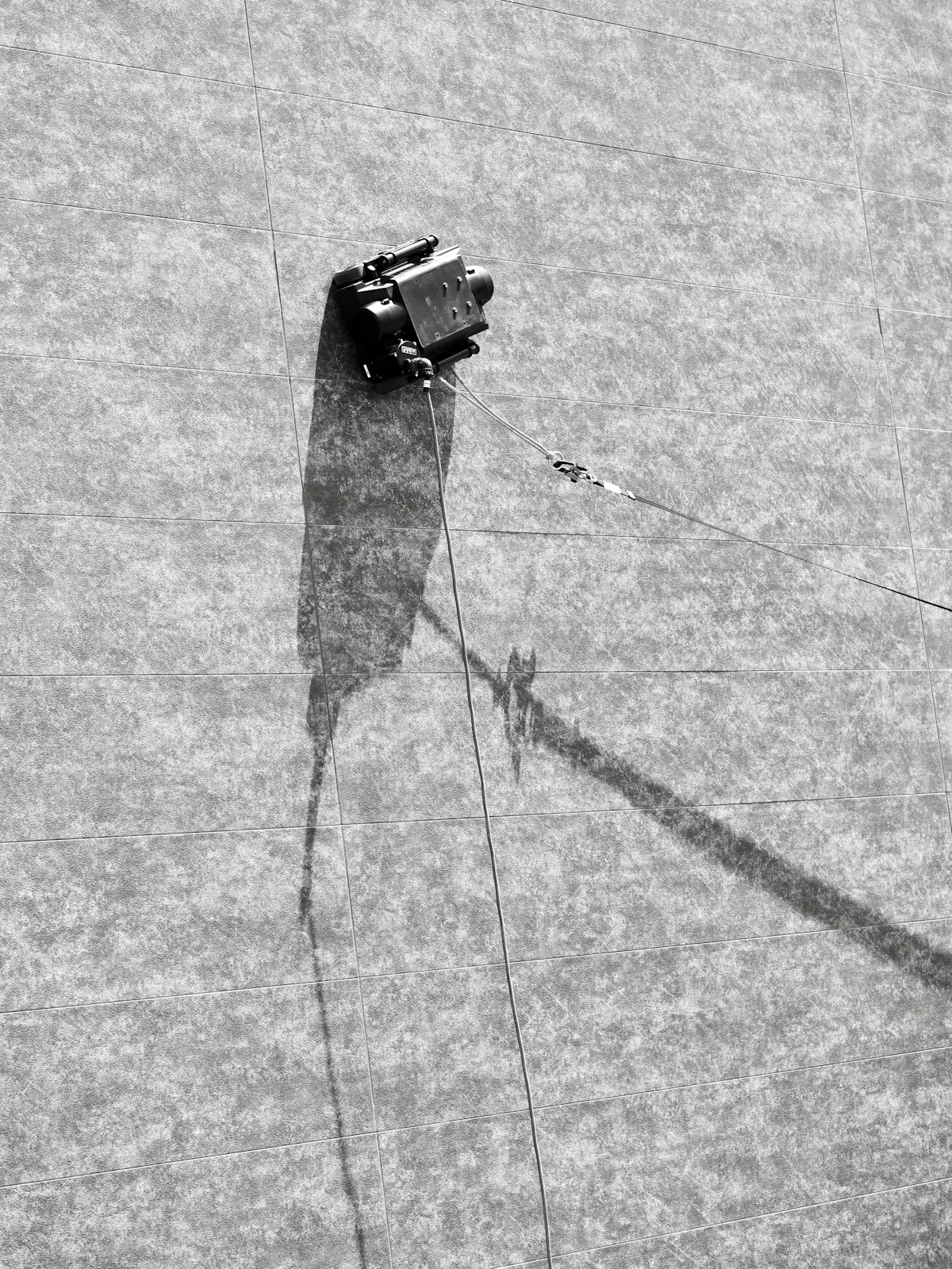 A robot operating on an industrial building — Physical AI deployments extend beyond stationary arms into mobile platforms.