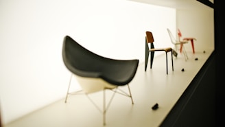 Several modern chairs displayed on a white stage.