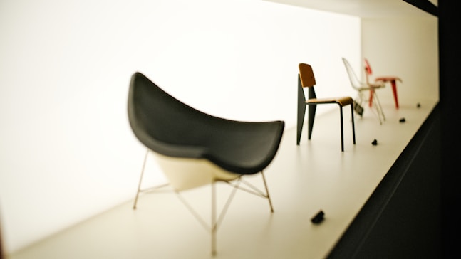 Several modern chairs displayed on a white stage.